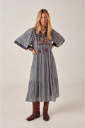Model wearing Maison Hotel Augusta Dress Bleu Picnic with floral embroidery styled with boots Shop Maison Hotel at Dotique