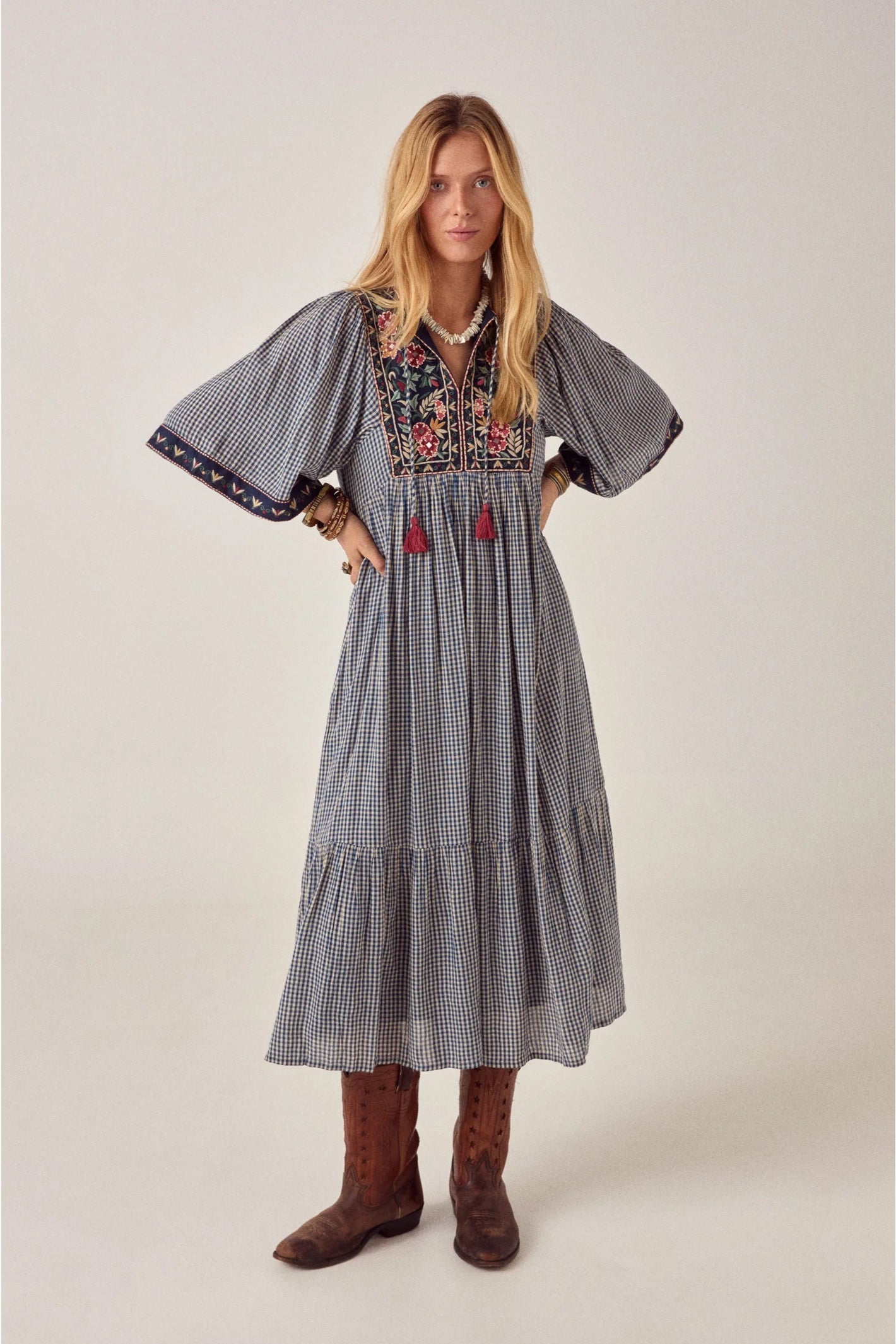 Model wearing Maison Hotel Augusta Dress Bleu Picnic with floral embroidery styled with boots Shop Maison Hotel at Dotique