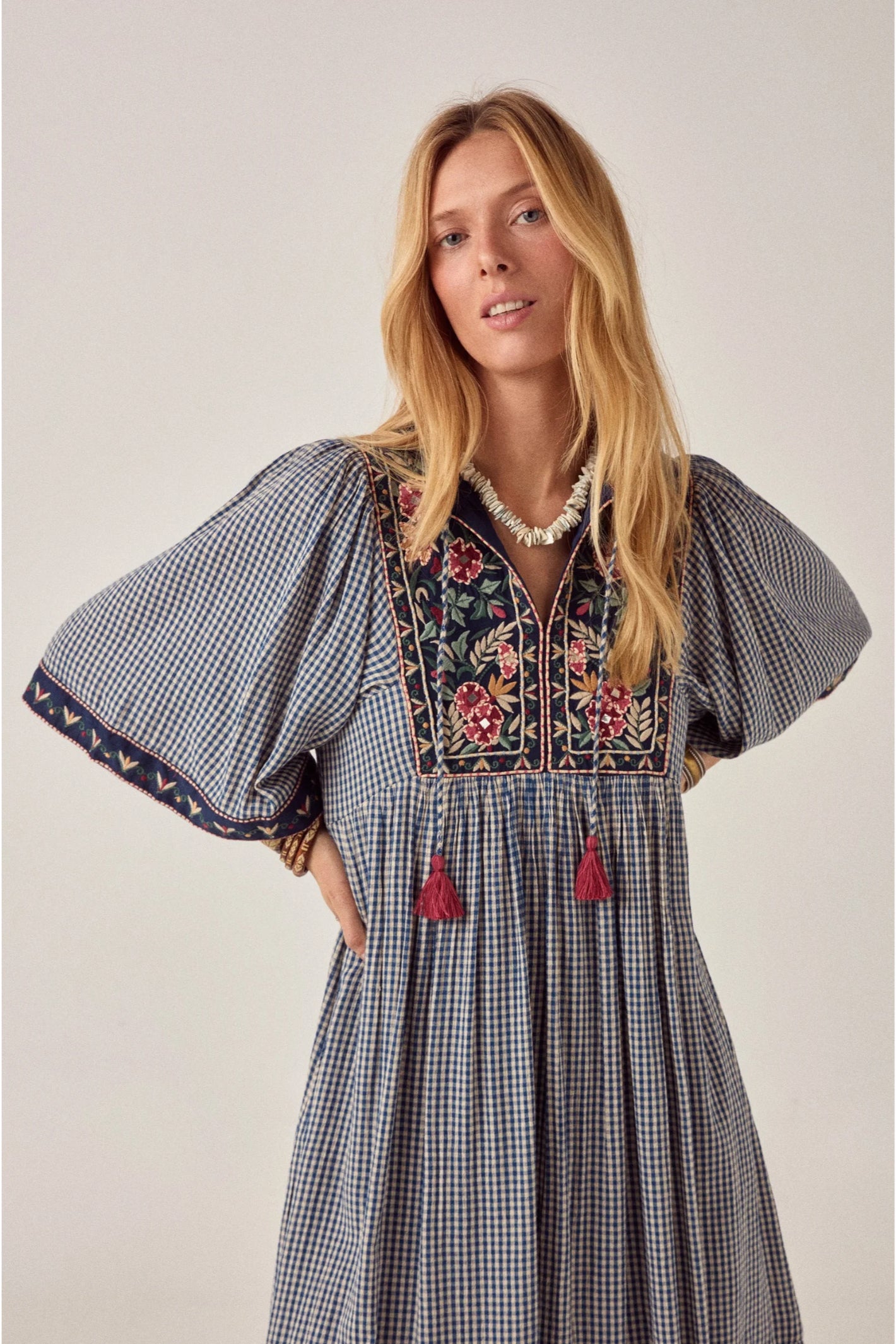 Model wearing Maison Hotel Augusta Dress Bleu Picnic with floral embroidery and puff sleeves Shop Maison Hotel at Dotique