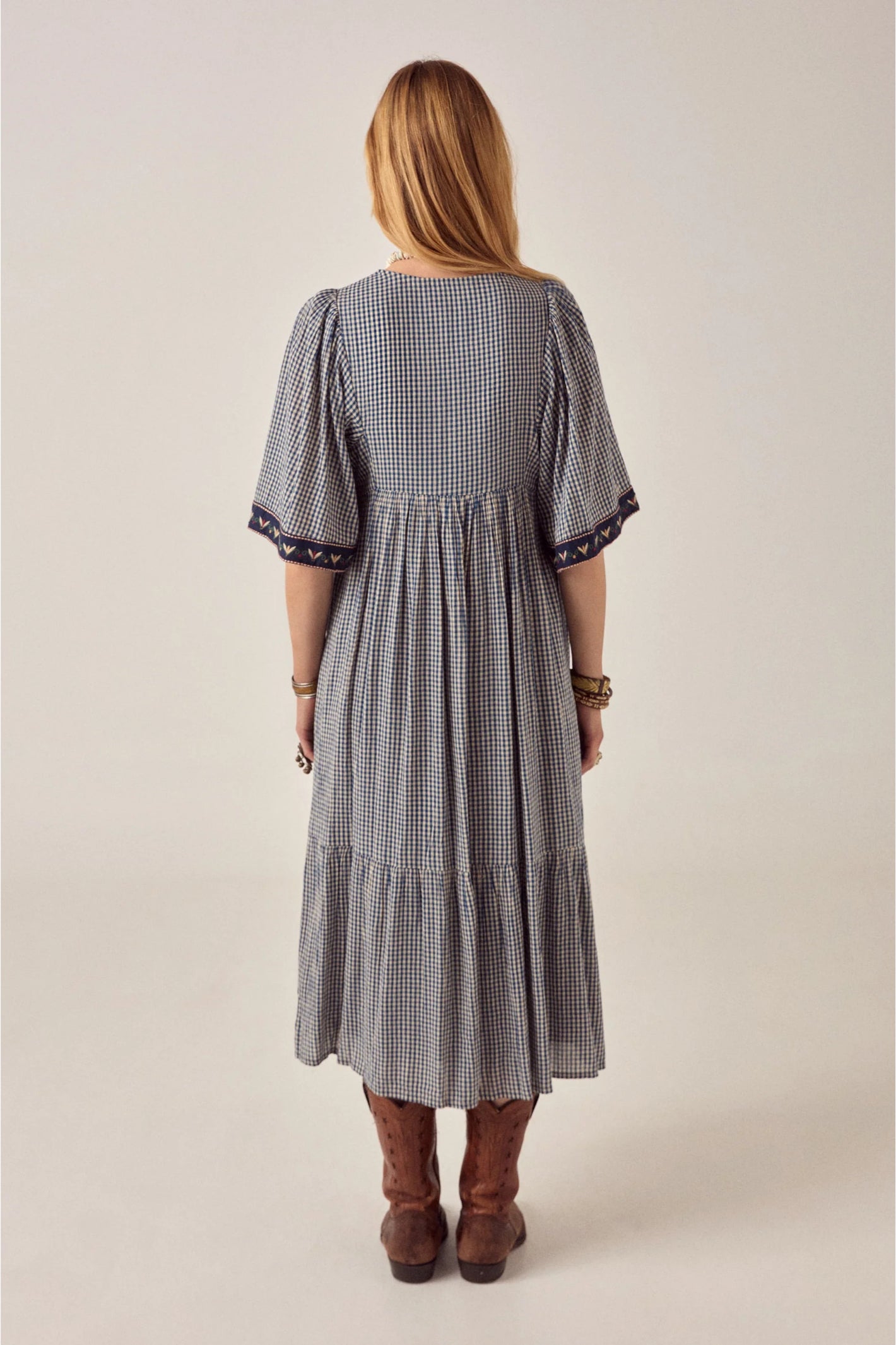 Back view of model wearing Maison Hotel Augusta Dress Bleu Picnic with puff sleeves and embroidered cuffs Shop Maison Hotel at Dotique