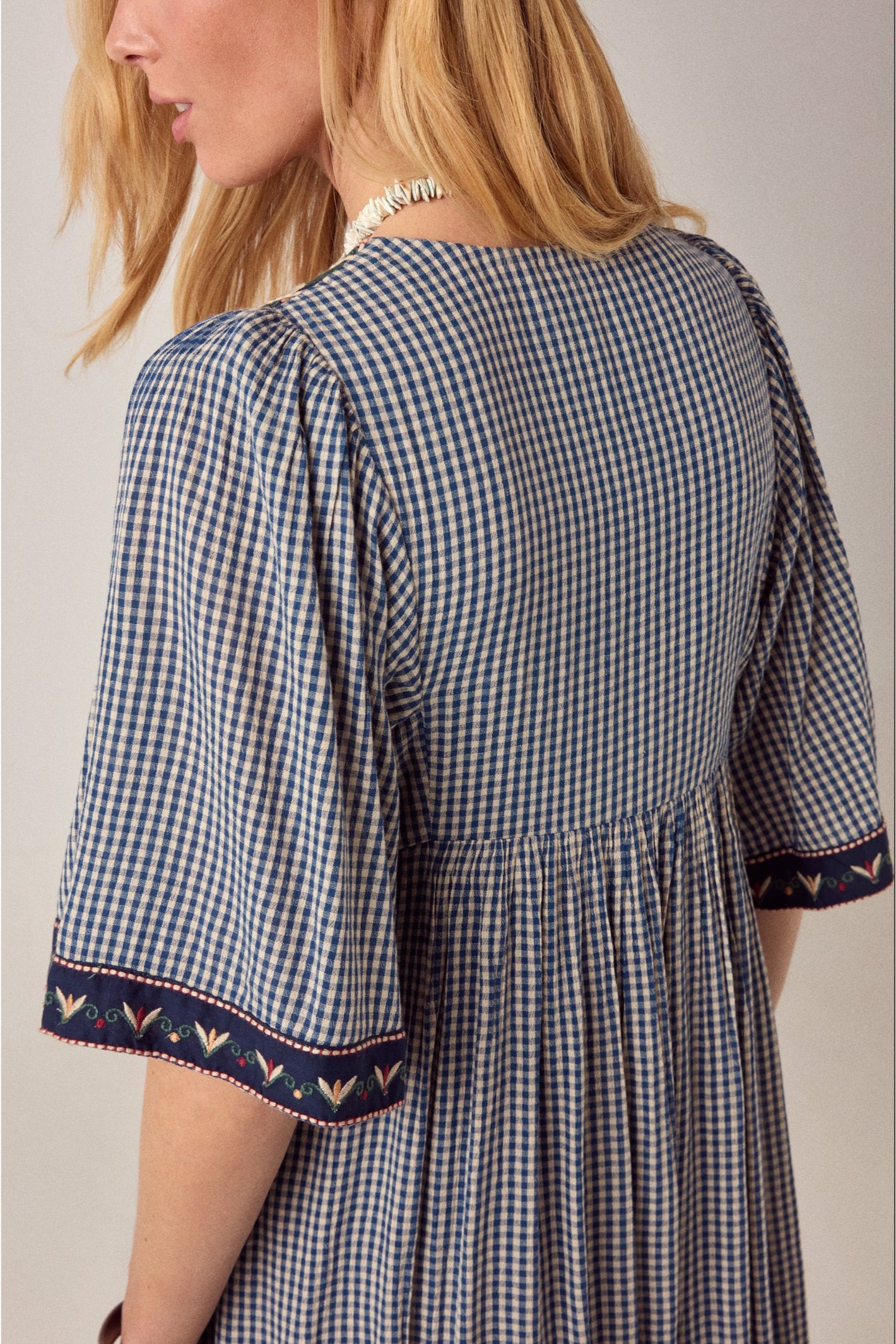 Back view of Maison Hotel Augusta Dress Bleu Picnic in check pattern with embroidered cuff detail Shop Maison Hotel at Dotique