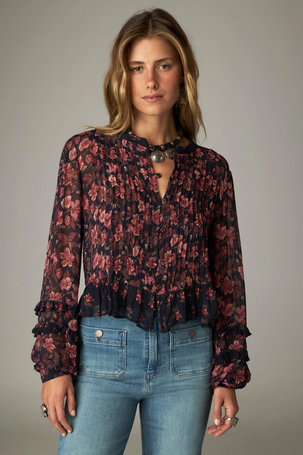Shop the Maison Hotel Lerele Blouse in Punk Pink at Dotique. A printed cropped blouse with a pleated front, band collar and ruffled hem.