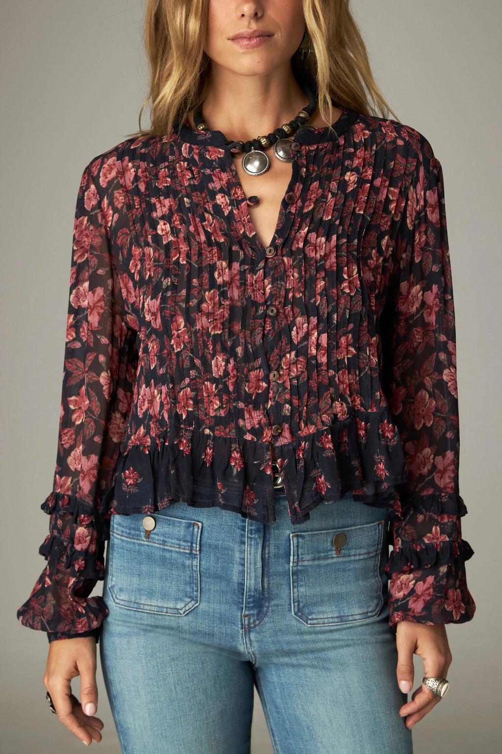 Shop the Maison Hotel Lerele Blouse in Punk Pink at Dotique. A printed cropped blouse with a pleated front, band collar and ruffled hem.