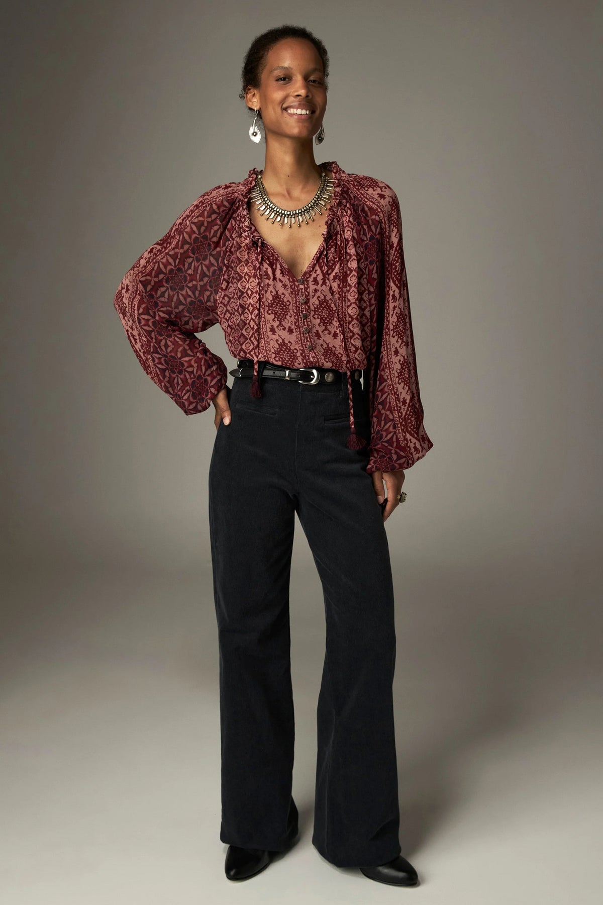 Shop the Maison Hotel Hannah Blouse in Wine at Dotique. A printed blouse with a ruffled neckline, tassel ties and voluminous sleeves.