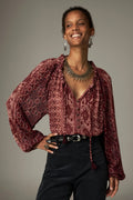 Shop the Maison Hotel Hannah Blouse in Wine at Dotique. A printed blouse with a ruffled neckline, tassel ties and voluminous sleeves.