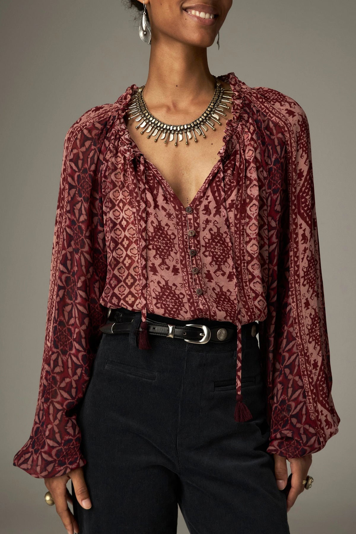 Shop the Maison Hotel Hannah Blouse in Wine at Dotique. A printed blouse with a ruffled neckline, tassel ties and voluminous sleeves.