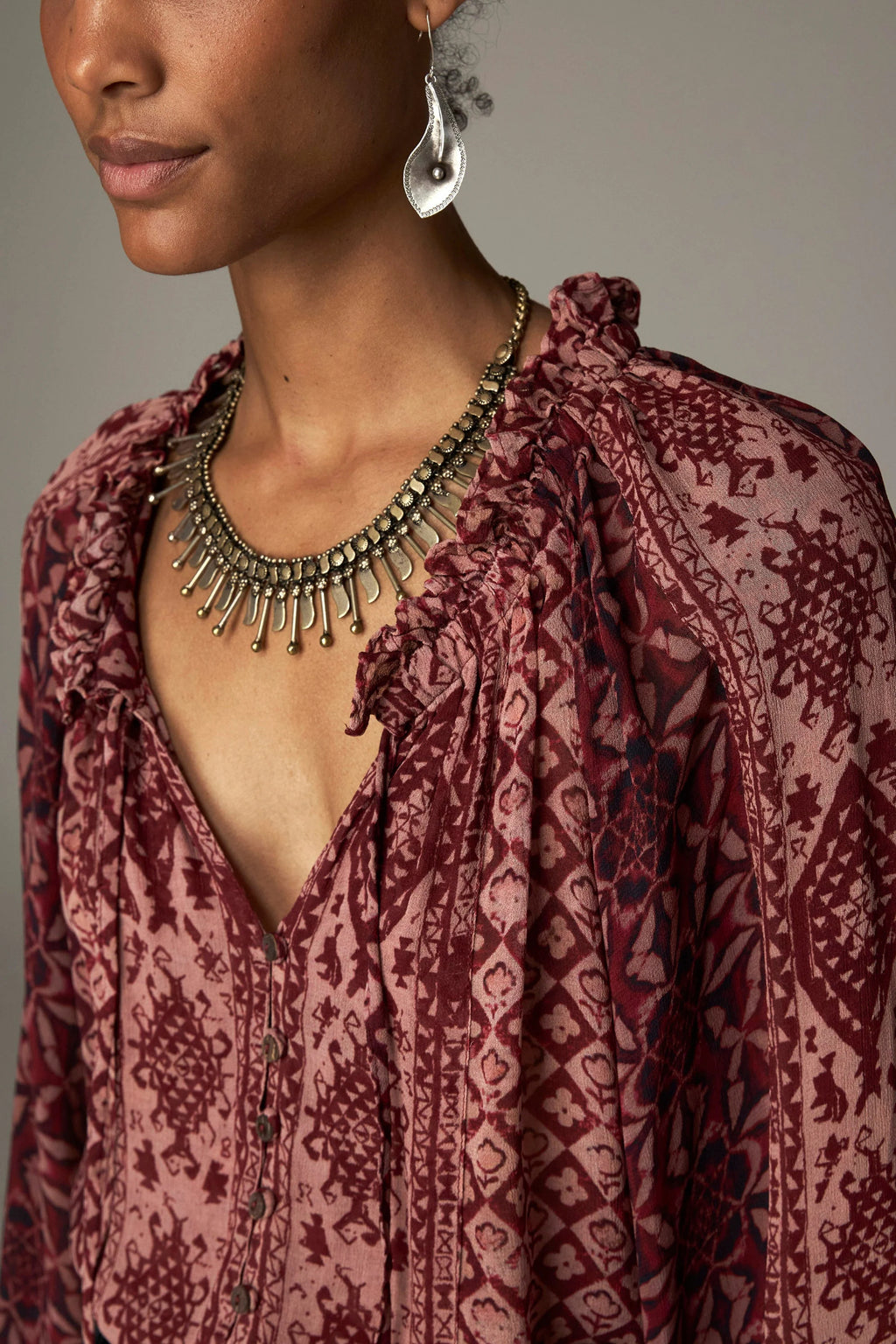 Shop the Maison Hotel Hannah Blouse in Wine at Dotique. A printed blouse with a ruffled neckline, tassel ties and voluminous sleeves.