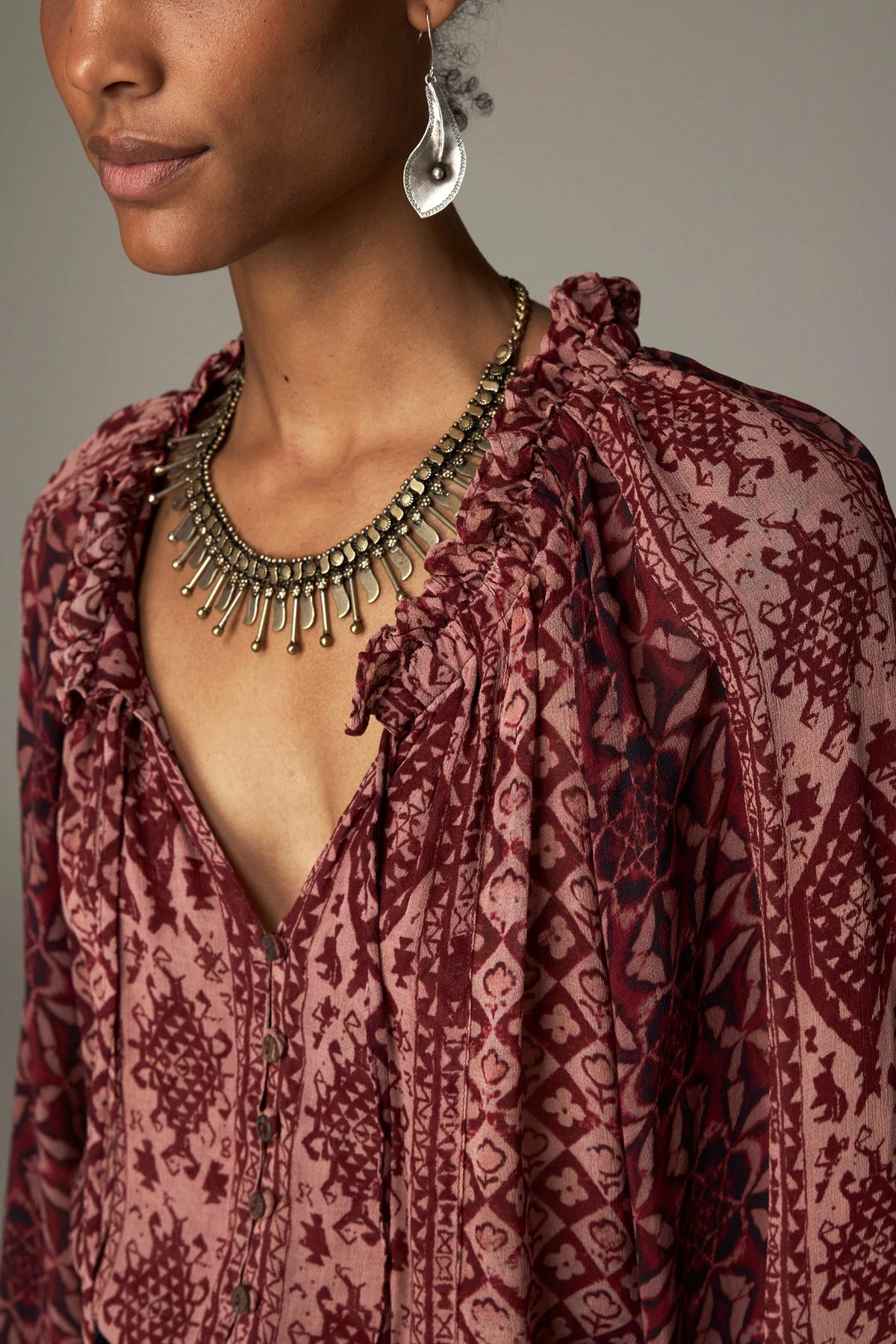 Shop the Maison Hotel Hannah Blouse in Wine at Dotique. A printed blouse with a ruffled neckline, tassel ties and voluminous sleeves.