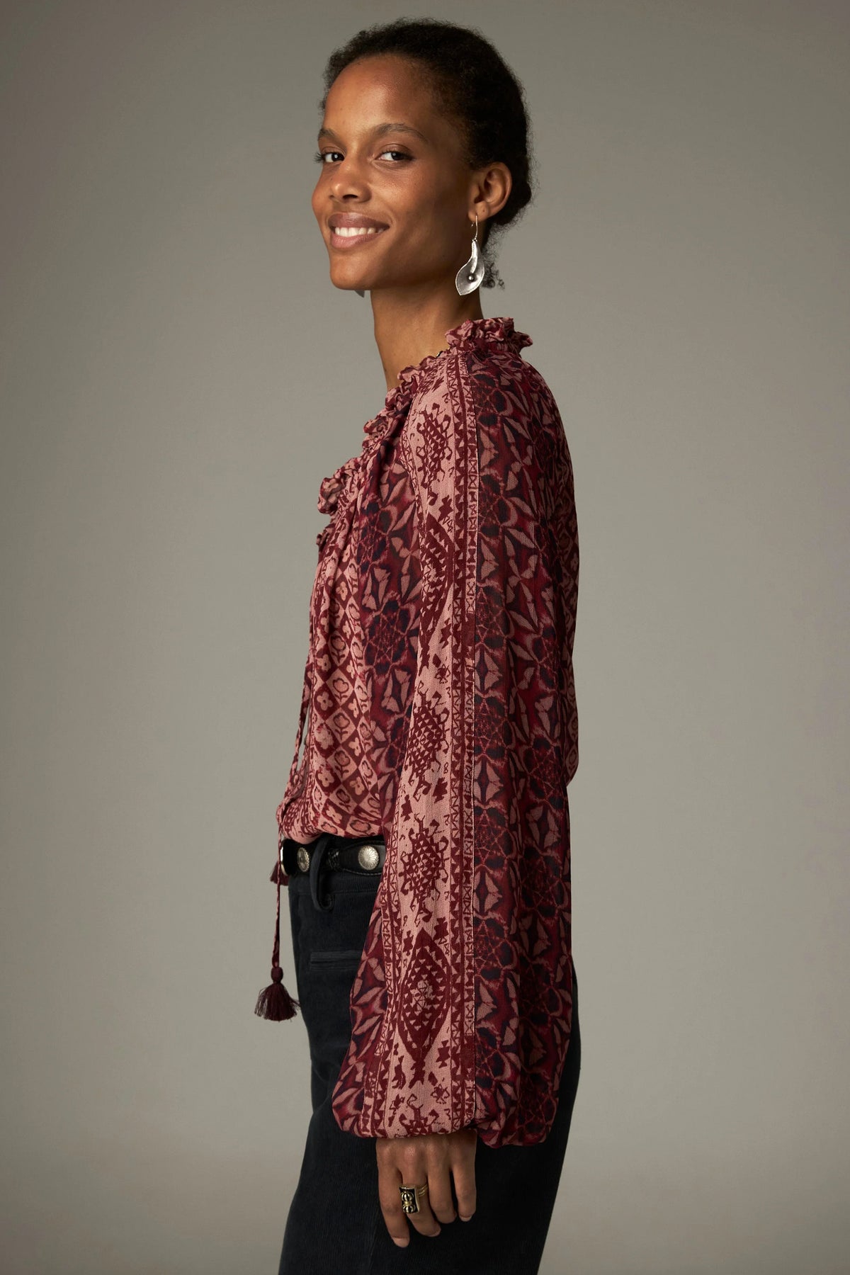 Shop the Maison Hotel Hannah Blouse in Wine at Dotique. A printed blouse with a ruffled neckline, tassel ties and voluminous sleeves.