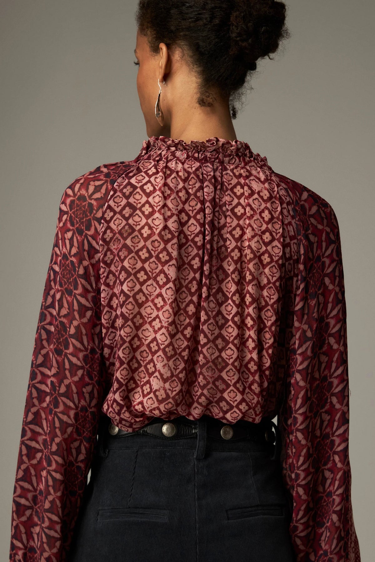 Shop the Maison Hotel Hannah Blouse in Wine at Dotique. A printed blouse with a ruffled neckline, tassel ties and voluminous sleeves.