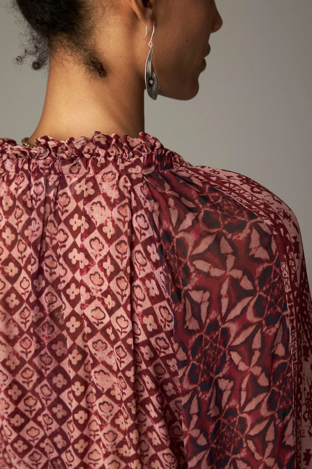 Shop the Maison Hotel Hannah Blouse in Wine at Dotique. A printed blouse with a ruffled neckline, tassel ties and voluminous sleeves.