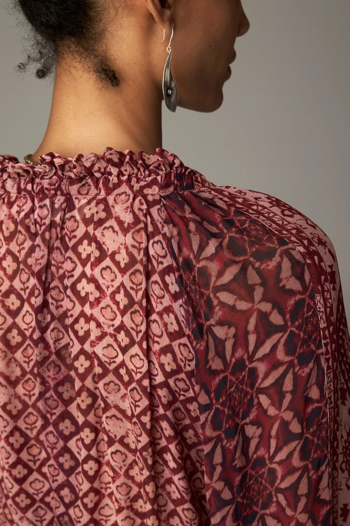 Shop the Maison Hotel Hannah Blouse in Wine at Dotique. A printed blouse with a ruffled neckline, tassel ties and voluminous sleeves.