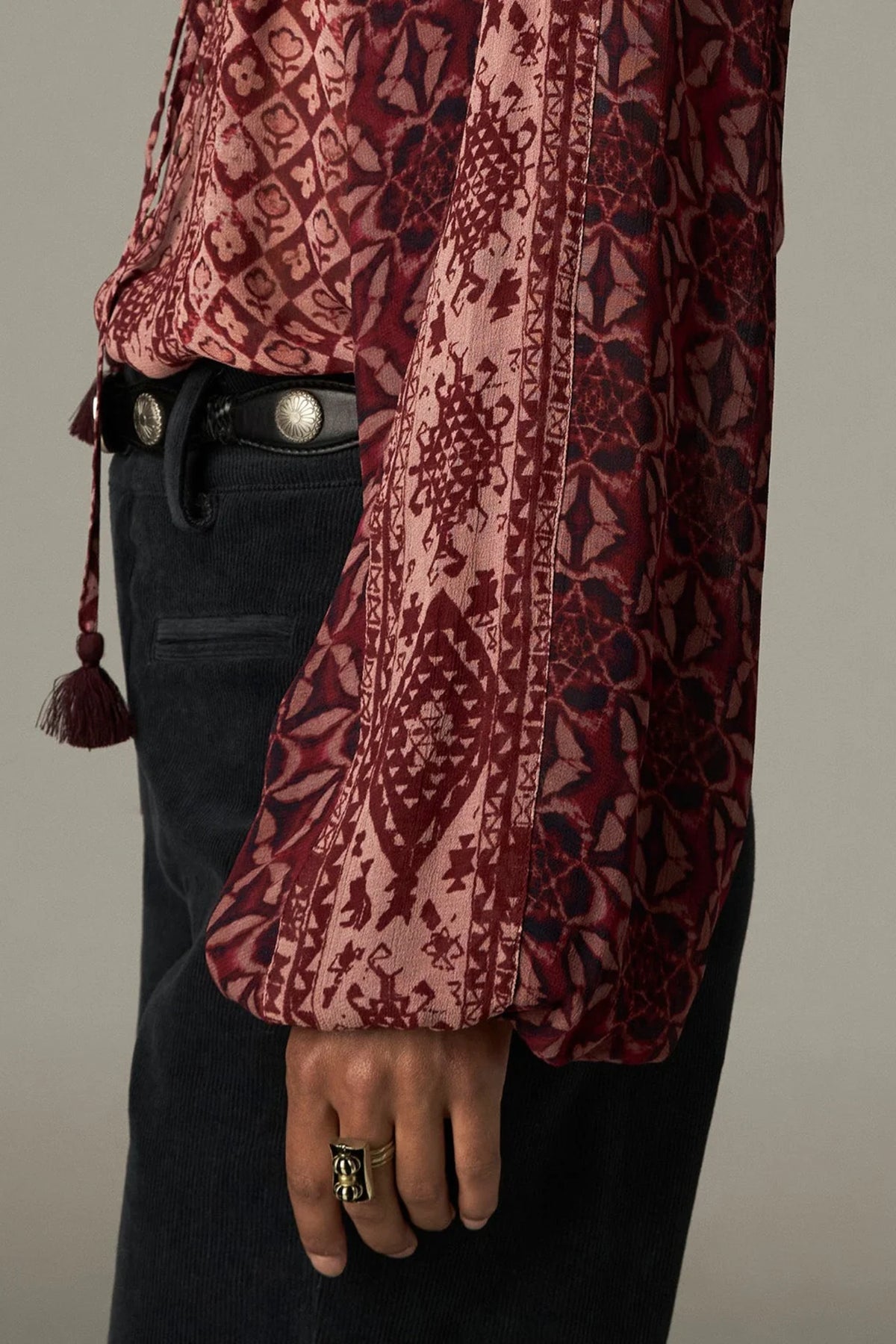 Shop the Maison Hotel Hannah Blouse in Wine at Dotique. A printed blouse with a ruffled neckline, tassel ties and voluminous sleeves.