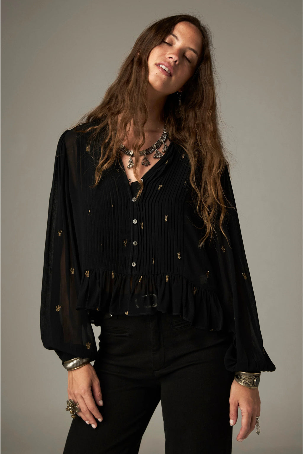 Shop the Maison Hotel Catherine Blouse in Blackout at Dotique. An embroidered black blouse with a cropped shape, ruffled hem and mother-of-pearl buttons.