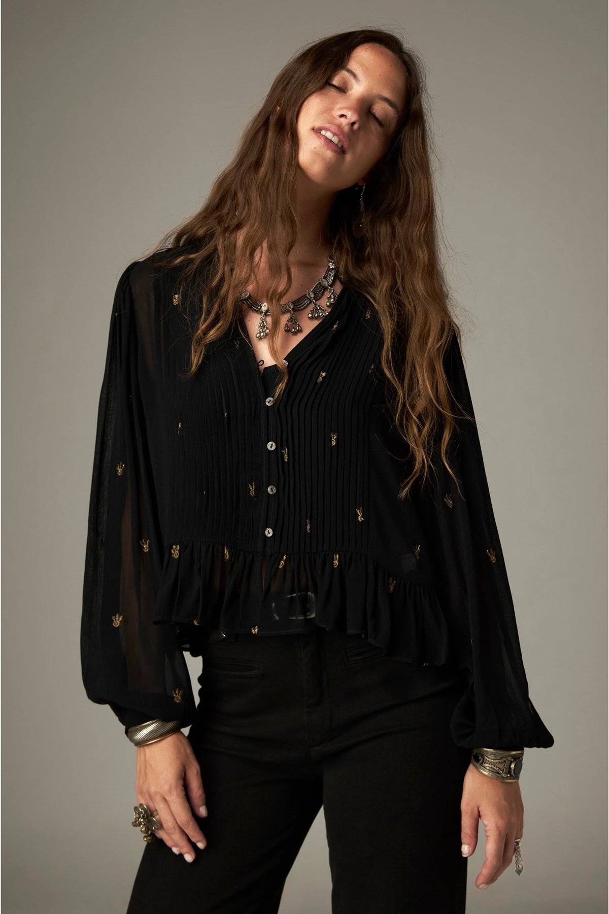 Shop the Maison Hotel Catherine Blouse in Blackout at Dotique. An embroidered black blouse with a cropped shape, ruffled hem and mother-of-pearl buttons.