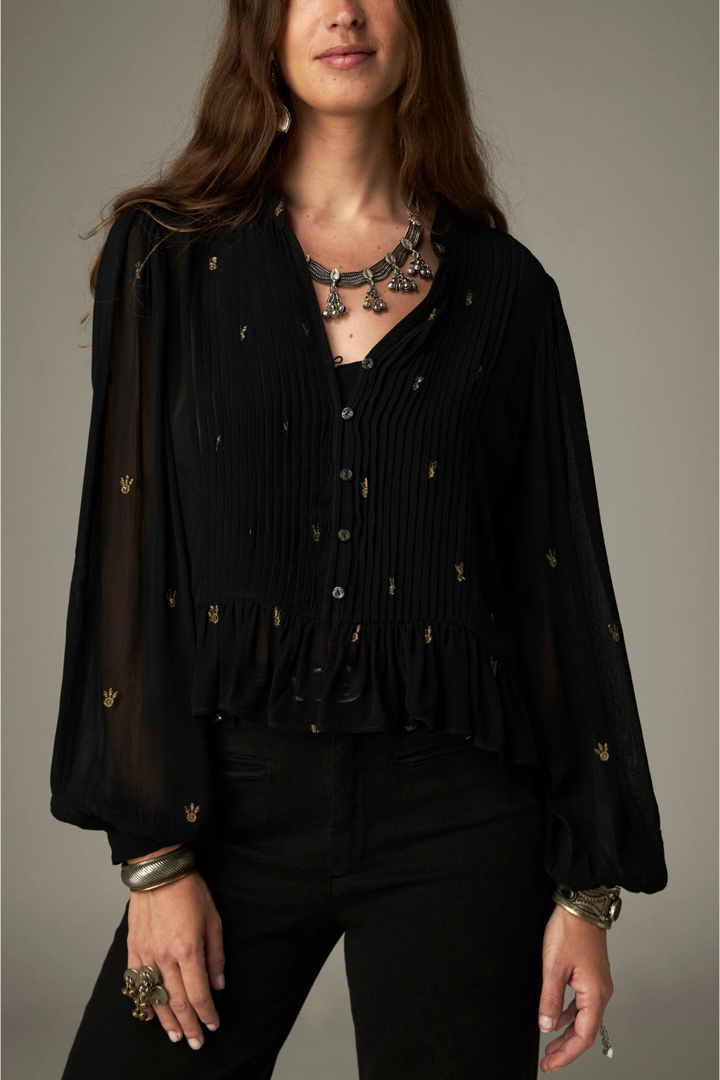 Shop the Maison Hotel Catherine Blouse in Blackout at Dotique. An embroidered black blouse with a cropped shape, ruffled hem and mother-of-pearl buttons.