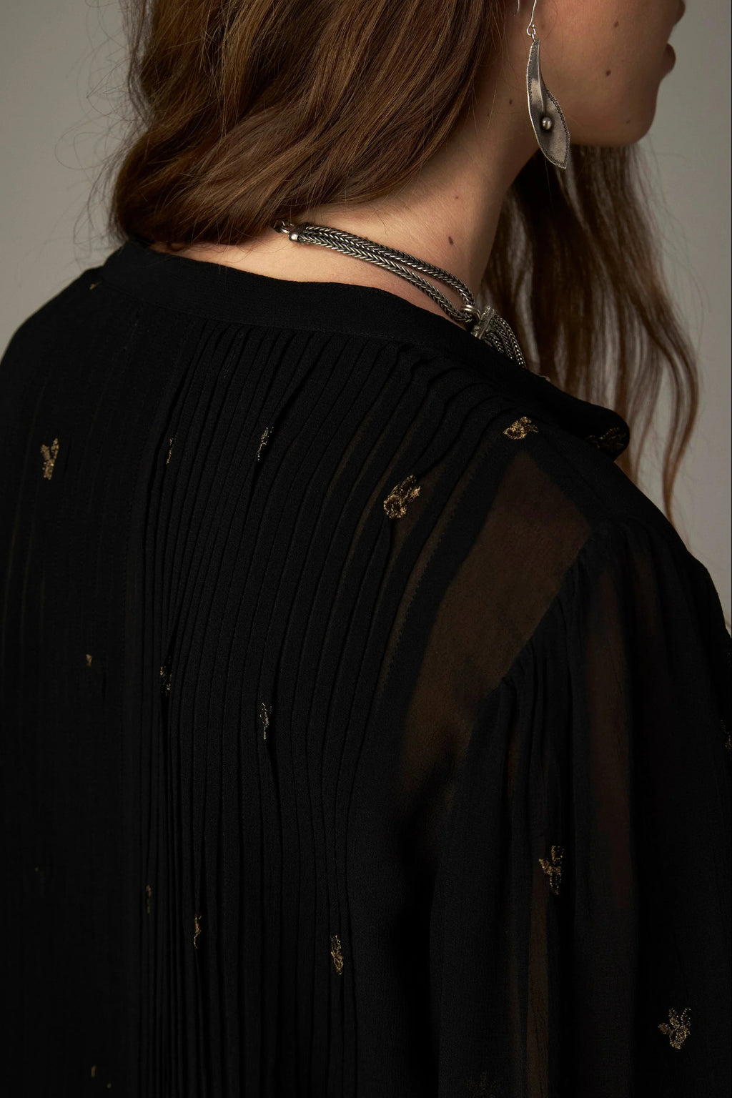 Shop the Maison Hotel Catherine Blouse in Blackout at Dotique. An embroidered black blouse with a cropped shape, ruffled hem and mother-of-pearl buttons.