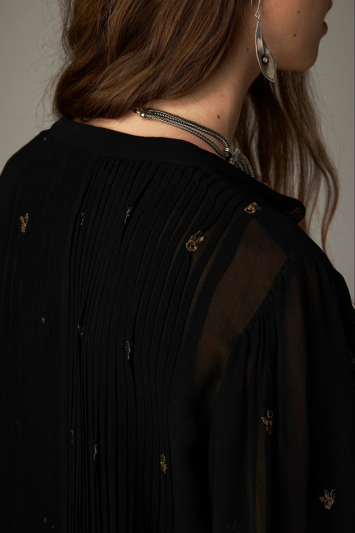 Shop the Maison Hotel Catherine Blouse in Blackout at Dotique. An embroidered black blouse with a cropped shape, ruffled hem and mother-of-pearl buttons.