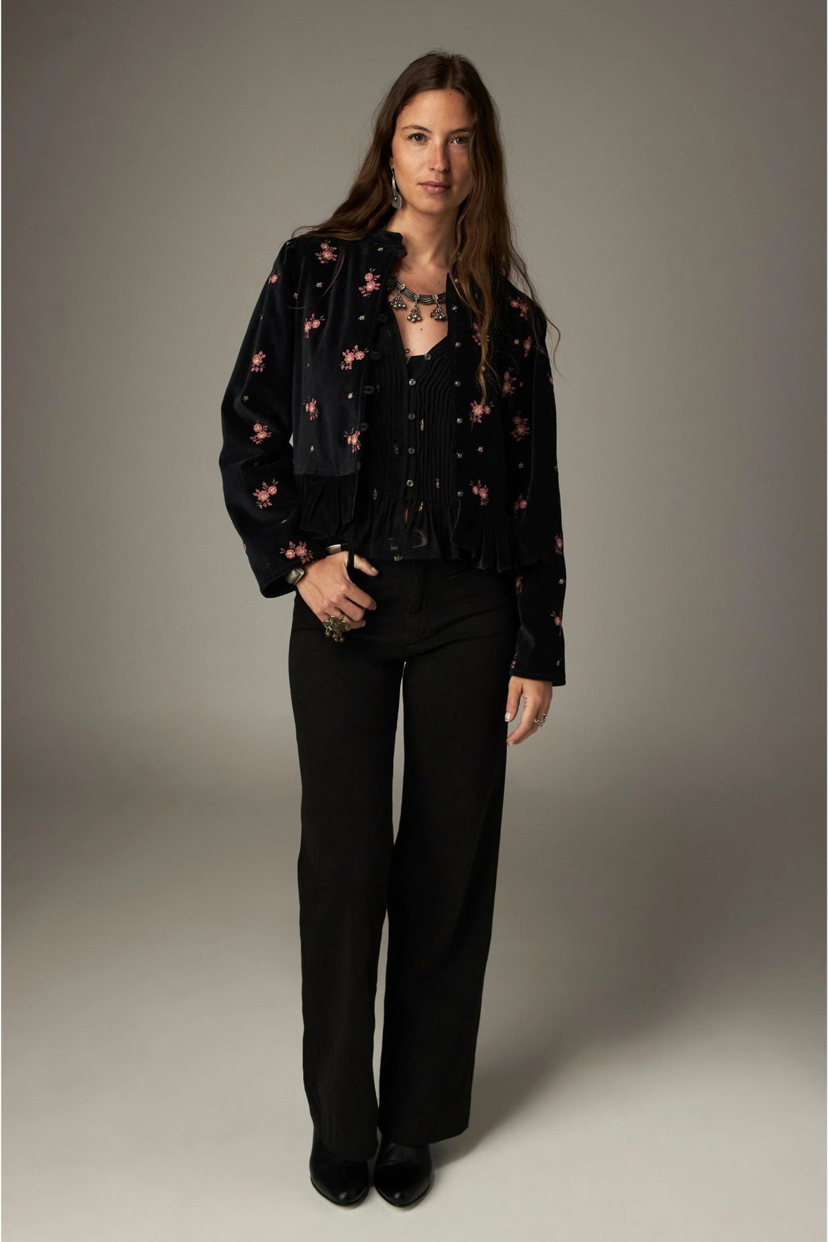 Shop the Maison Hotel Catherine Blouse in Blackout at Dotique. An embroidered black blouse with a cropped shape, ruffled hem and mother-of-pearl buttons.