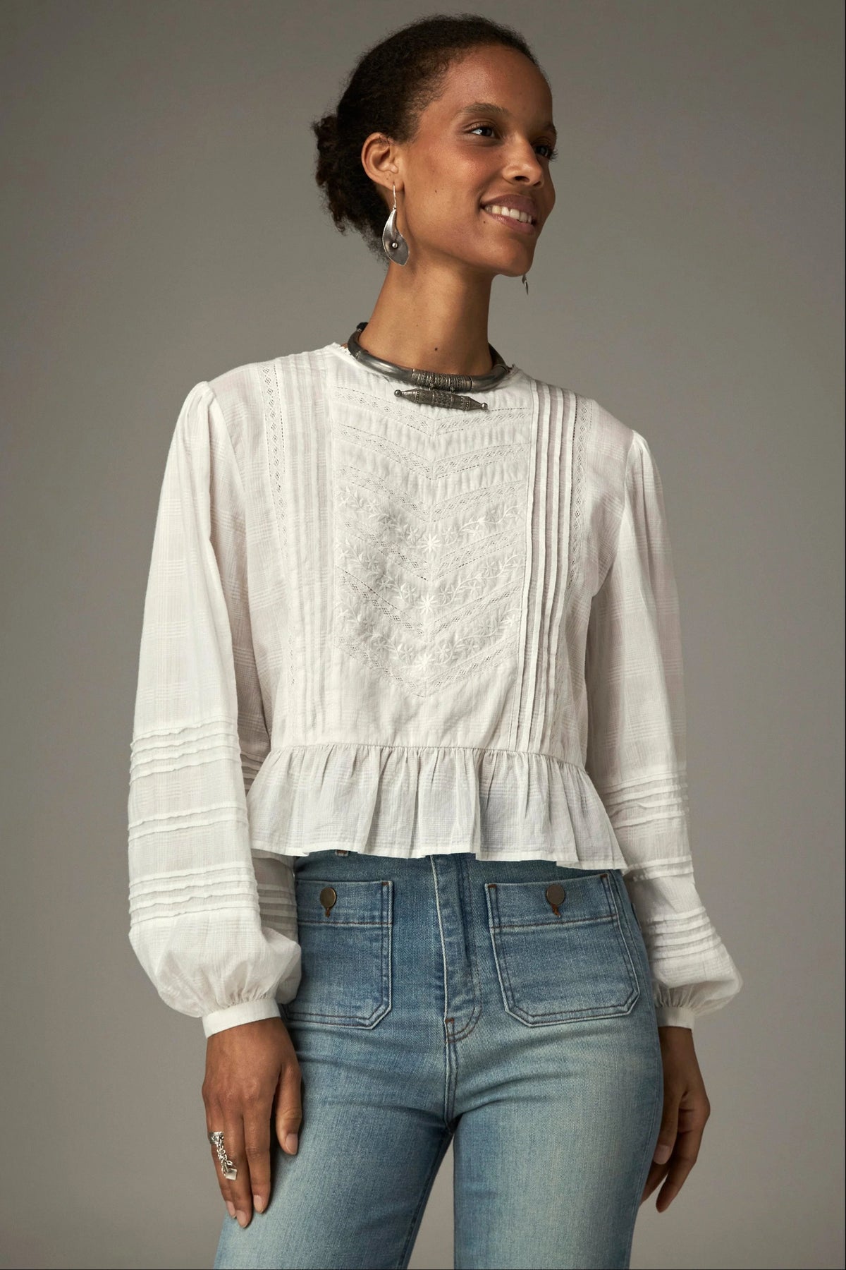 Shop the Maison Hotel Mildred Blouse in Bone at Dotique. A cropped cotton blouse with pintuck detailing, lace-trim neckline and a pretty ruffled hem.