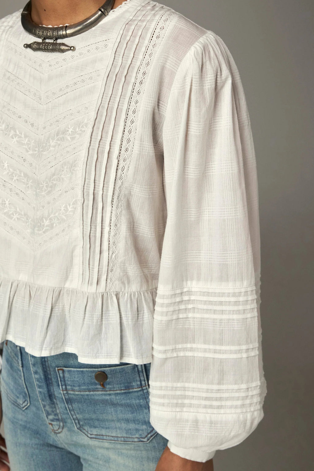 Shop the Maison Hotel Mildred Blouse in Bone at Dotique. A cropped cotton blouse with pintuck detailing, lace-trim neckline and a pretty ruffled hem.