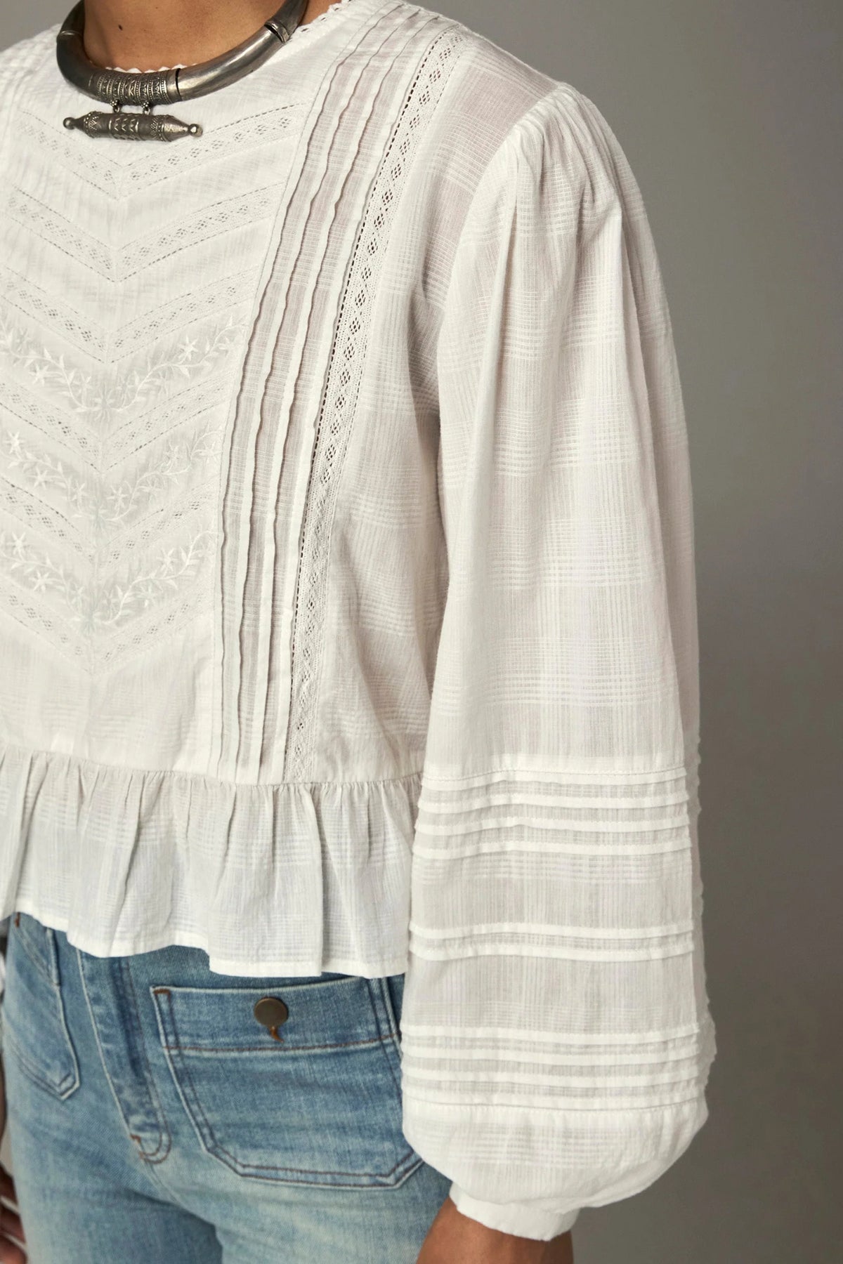 Shop the Maison Hotel Mildred Blouse in Bone at Dotique. A cropped cotton blouse with pintuck detailing, lace-trim neckline and a pretty ruffled hem.