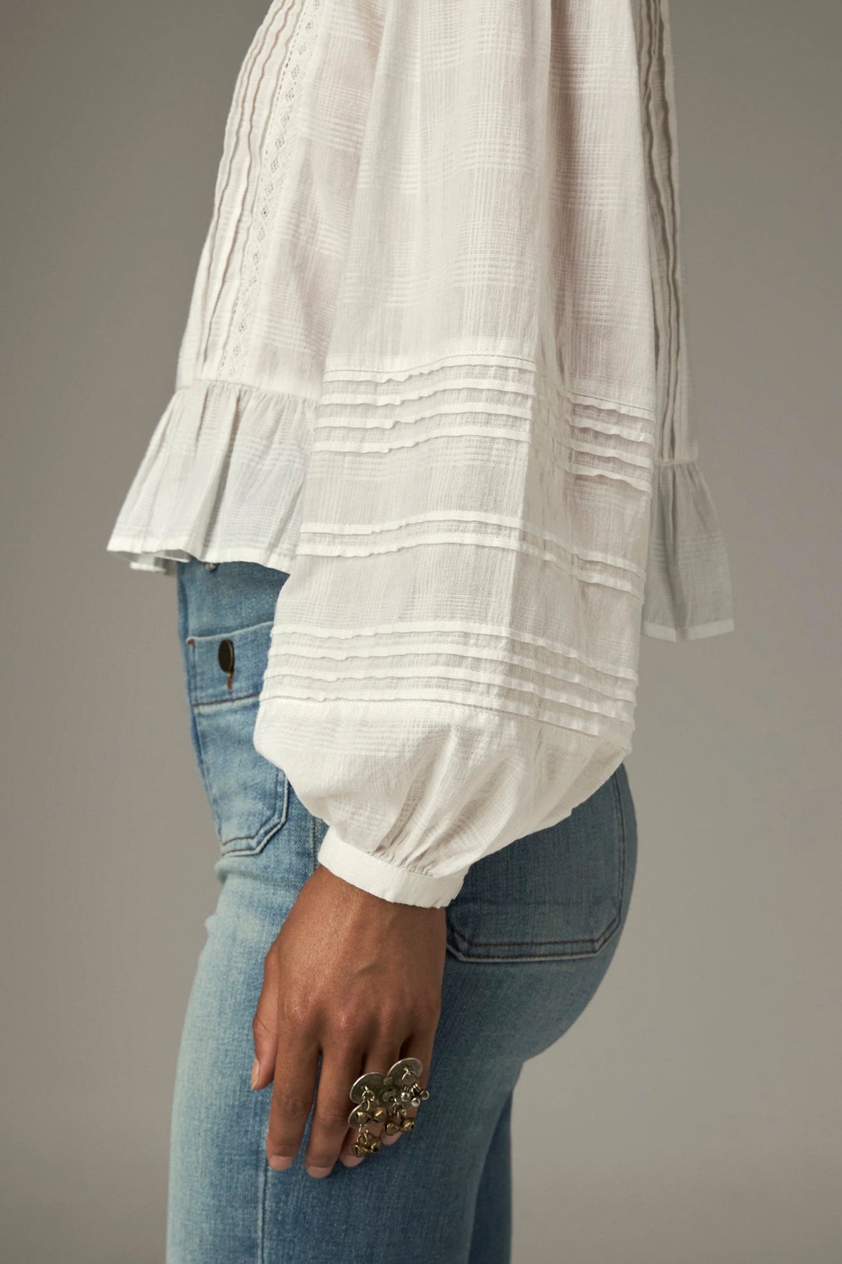 Shop the Maison Hotel Mildred Blouse in Bone at Dotique. A cropped cotton blouse with pintuck detailing, lace-trim neckline and a pretty ruffled hem.
