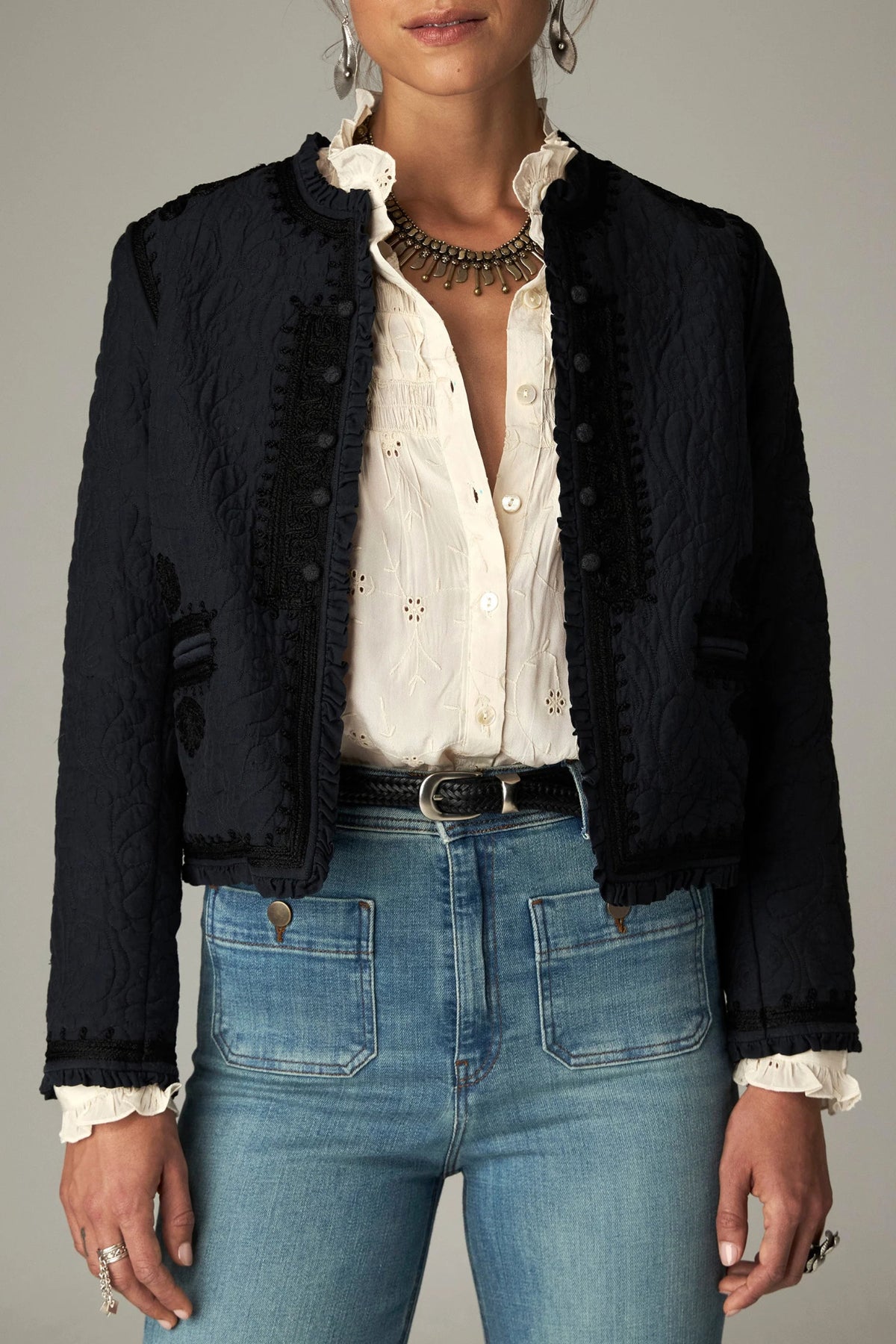 Shop the Maison Hotel Paco Jacket in Ceniza at Dotique. A cropped collarless jacket with embroidered trims, an open front and patch pockets.