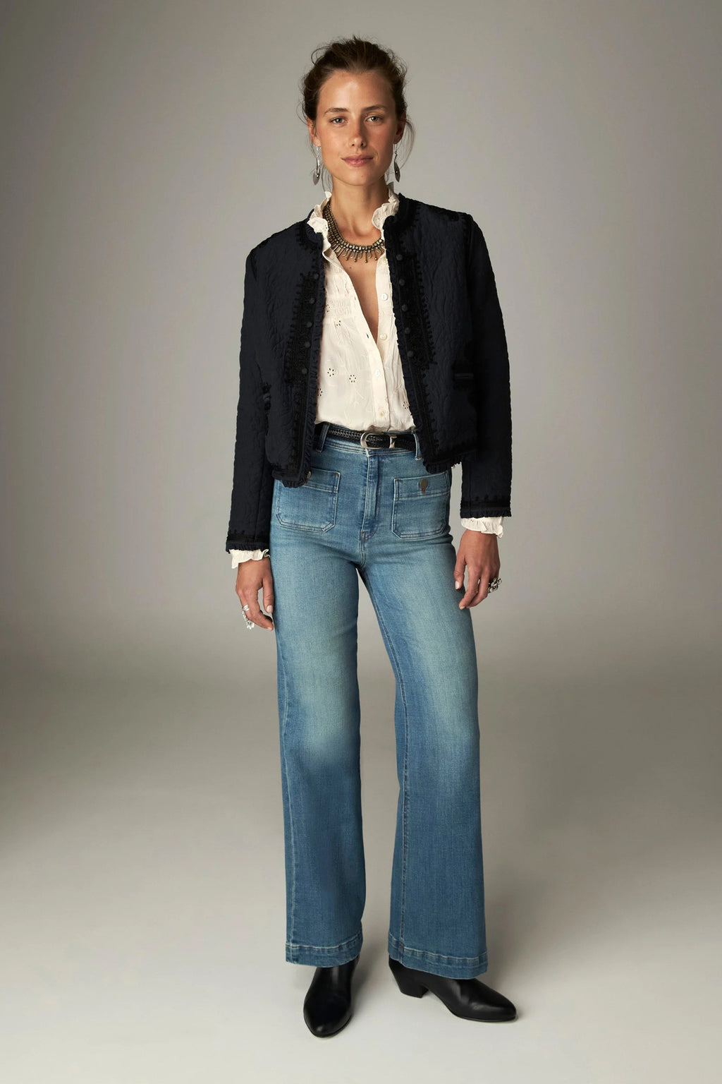 Shop the Maison Hotel Paco Jacket in Ceniza at Dotique. A cropped collarless jacket with embroidered trims, an open front and patch pockets.