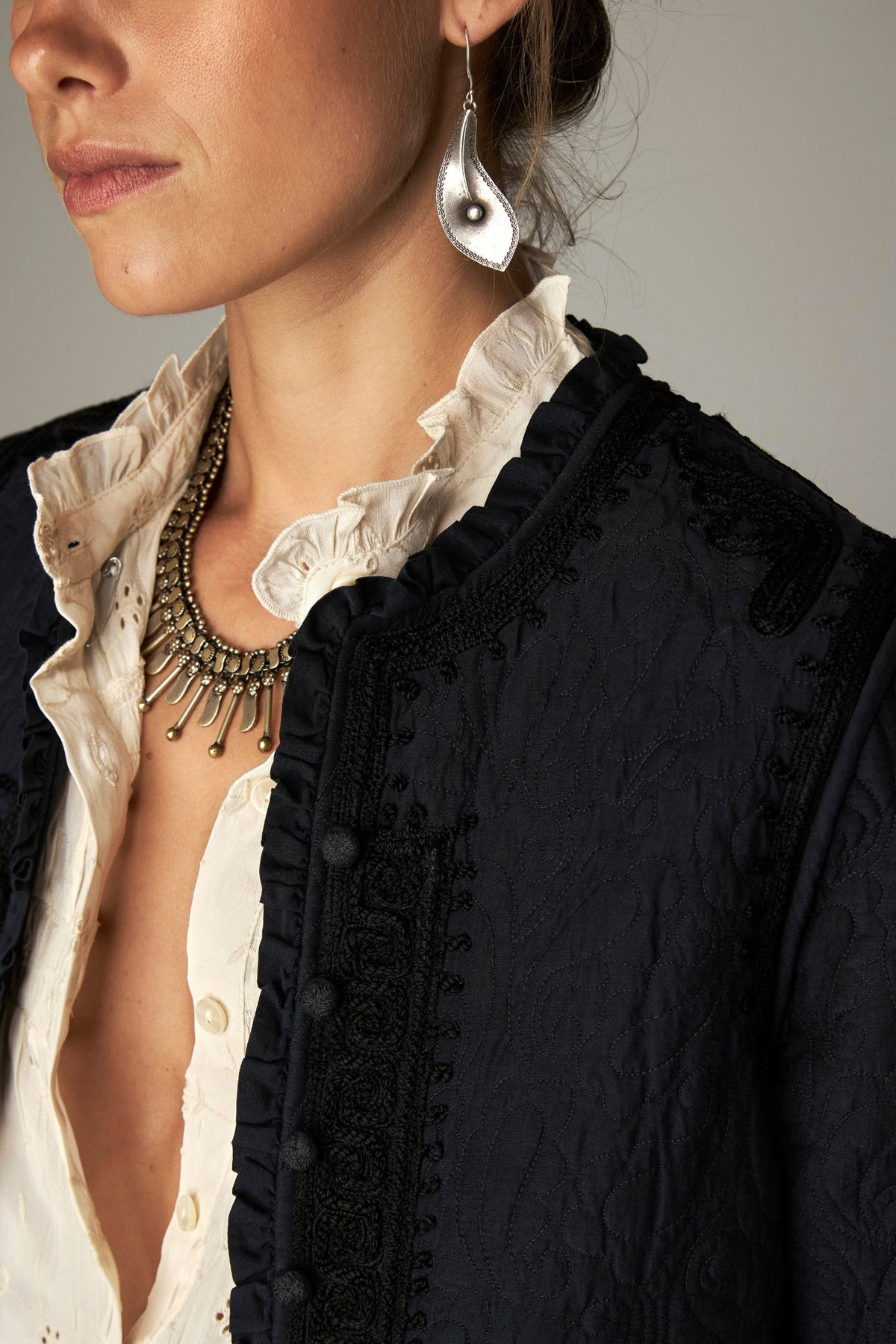 Shop the Maison Hotel Paco Jacket in Ceniza at Dotique. A cropped collarless jacket with embroidered trims, an open front and patch pockets.