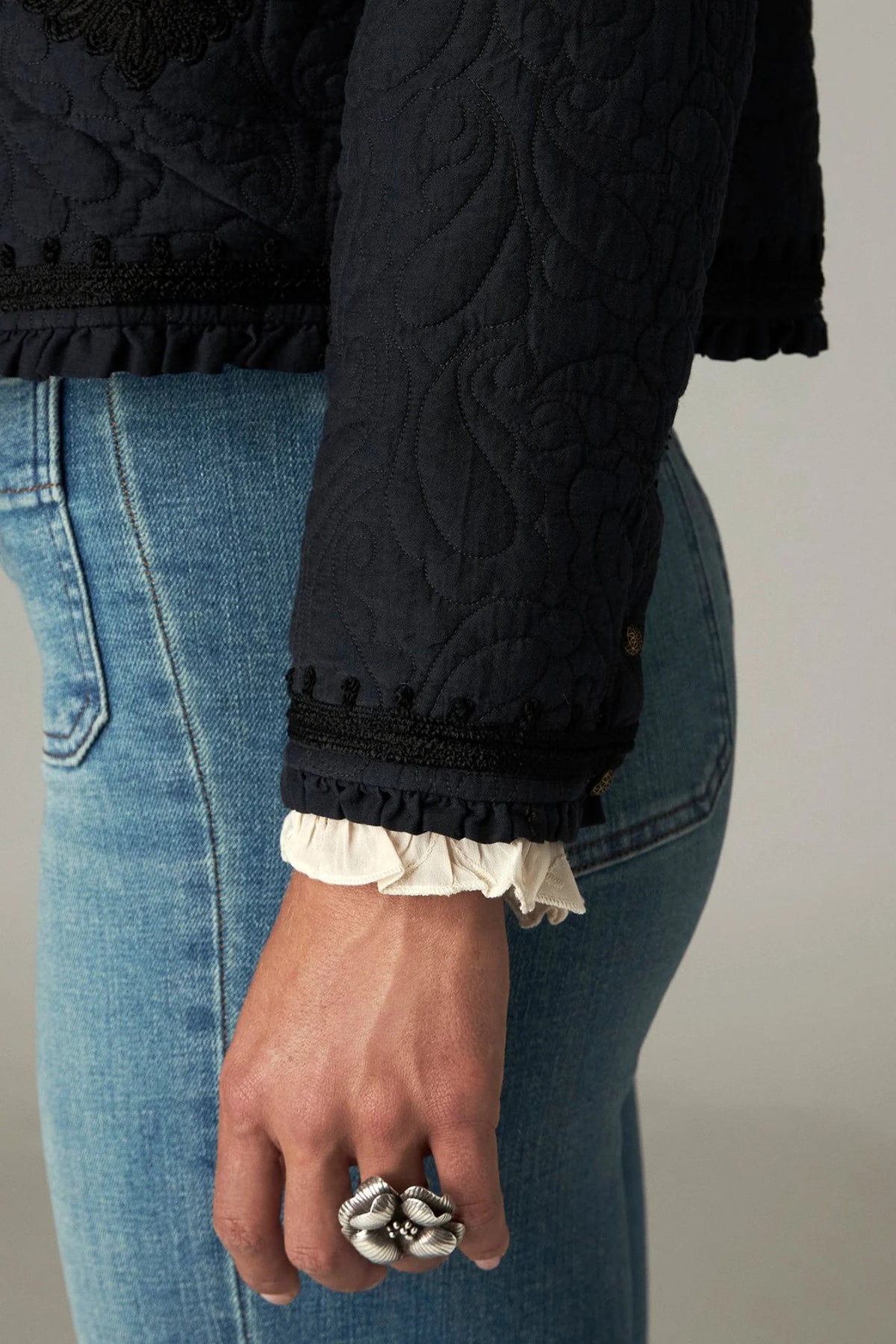 Shop the Maison Hotel Paco Jacket in Ceniza at Dotique. A cropped collarless jacket with embroidered trims, an open front and patch pockets.