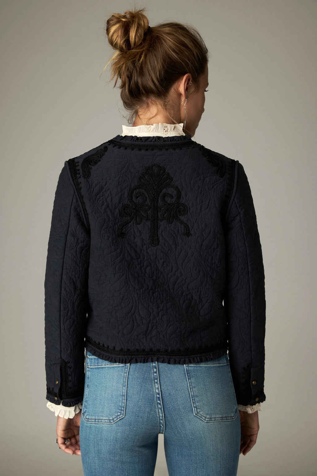 Shop the Maison Hotel Paco Jacket in Ceniza at Dotique. A cropped collarless jacket with embroidered trims, an open front and patch pockets.