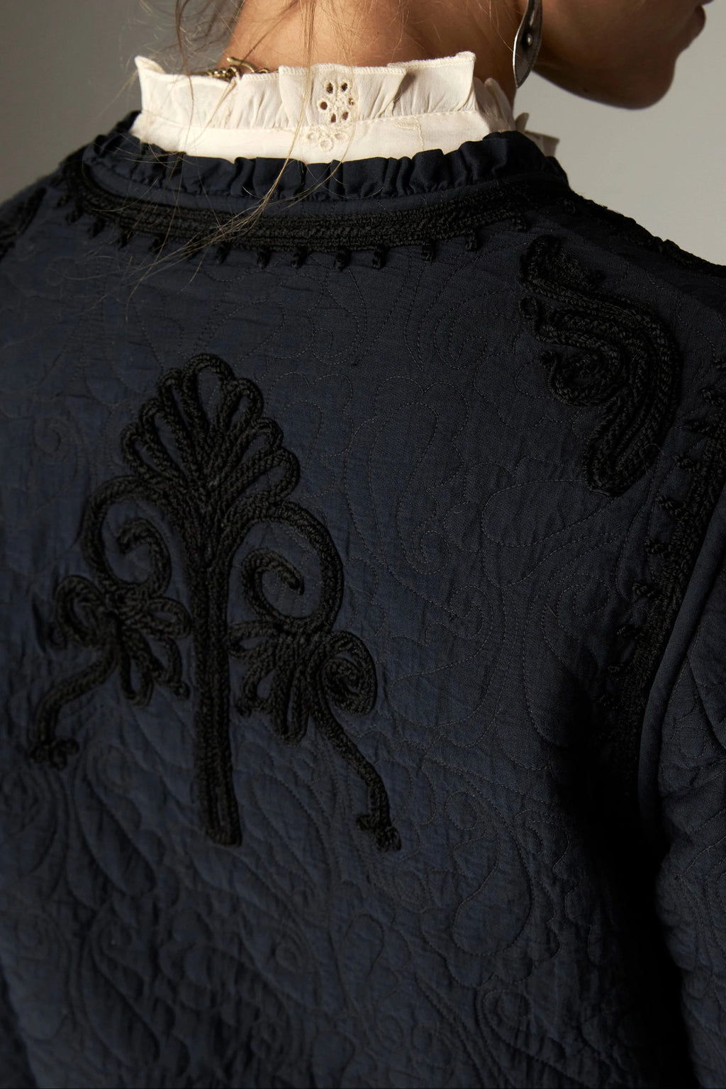 Shop the Maison Hotel Paco Jacket in Ceniza at Dotique. A cropped collarless jacket with embroidered trims, an open front and patch pockets.
