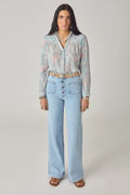 Woman wearing Maison Hotel Rani Shirt Misty Garden with light floral print, styled with jeans, shop Maison Hotel at Dotique