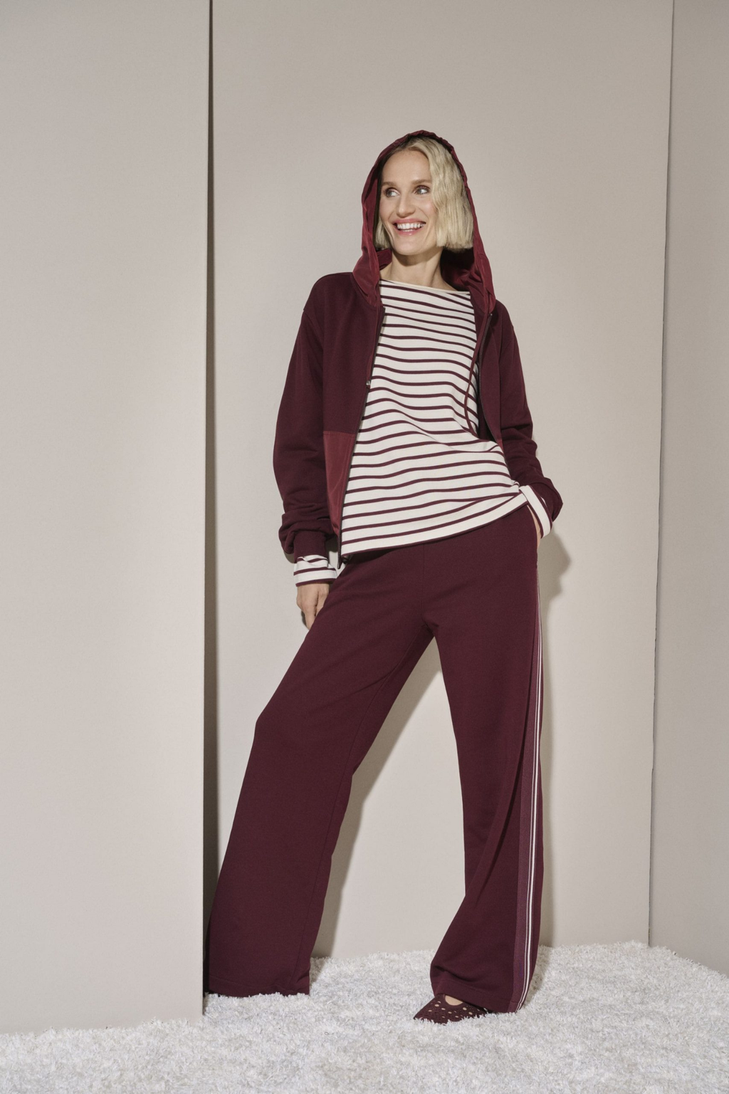 Shop the Margittes Wide Leg Jogging Trousers in burgundy at Dotique. Cotton-rich pull-on trousers with a wide-leg fit and contrast cream side stripe for effortless everyday style.