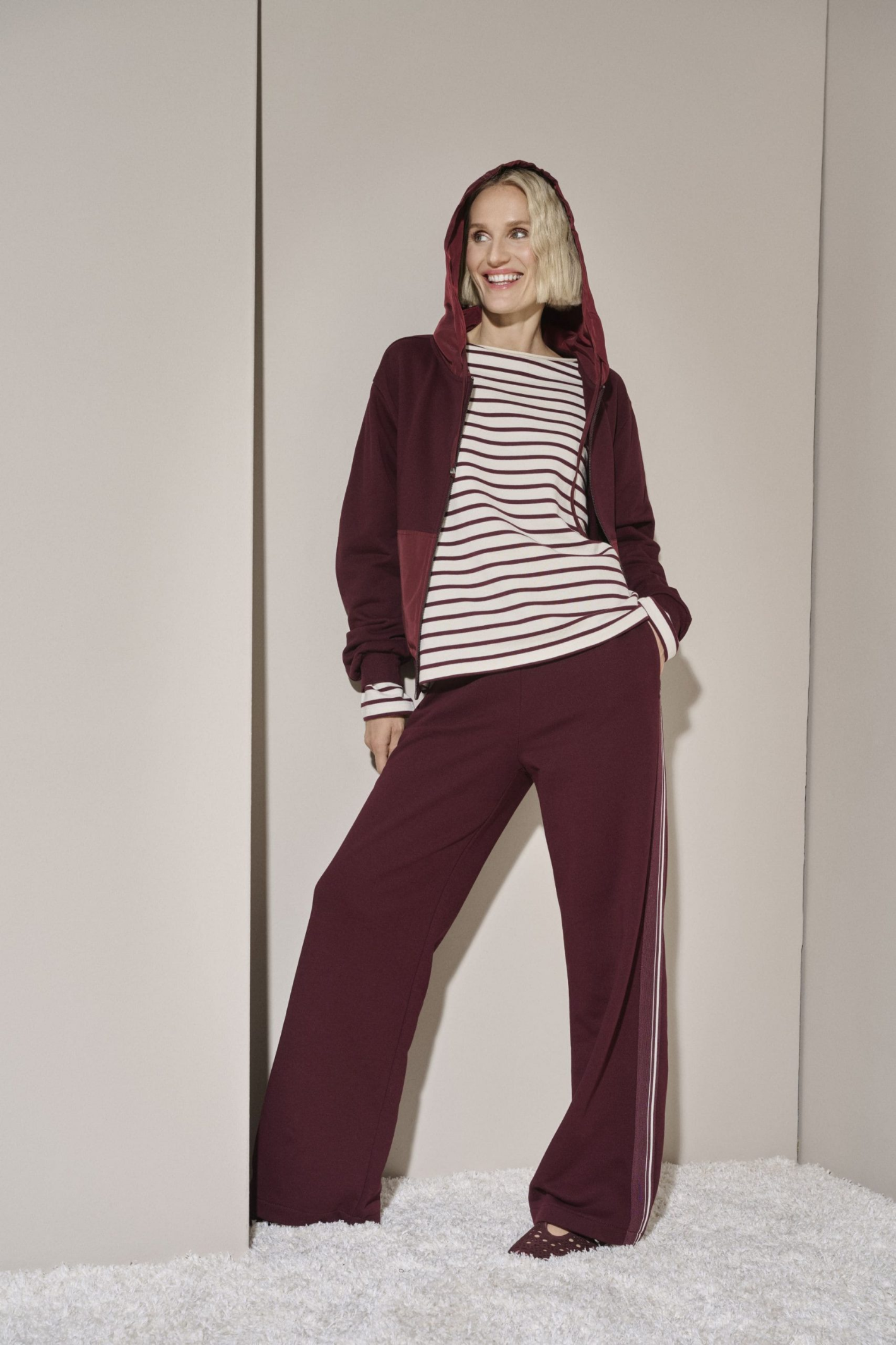 Shop the Margittes Wide Leg Jogging Trousers in burgundy at Dotique. Cotton-rich pull-on trousers with a wide-leg fit and contrast cream side stripe for effortless everyday style.