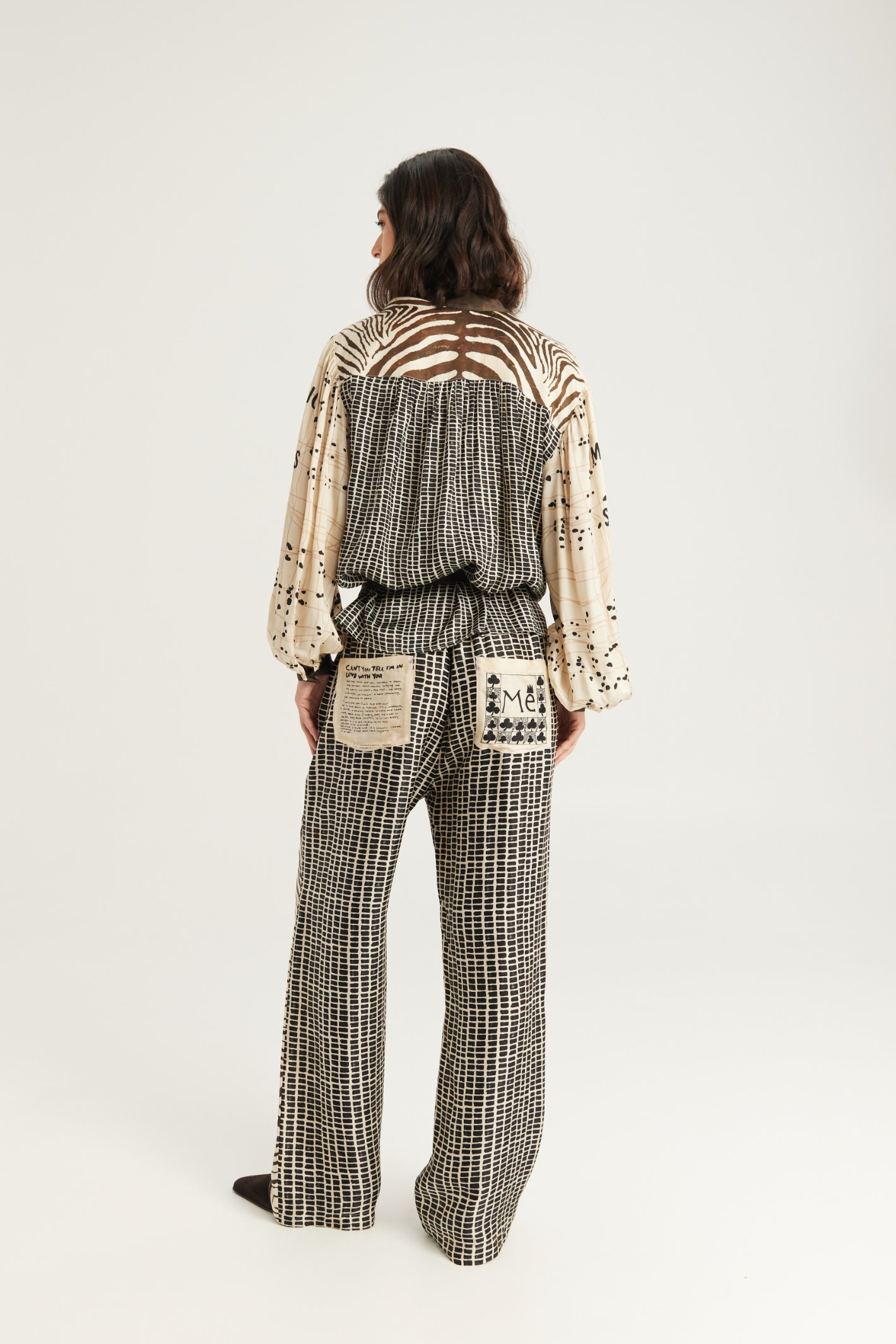 Shop the ME369 Bailey Straight Leg Track Pants in Noir Muse at Dotique. Soft viscose blend trousers with an artistic monochrome print, contrast pockets and a relaxed straight-leg fit.
