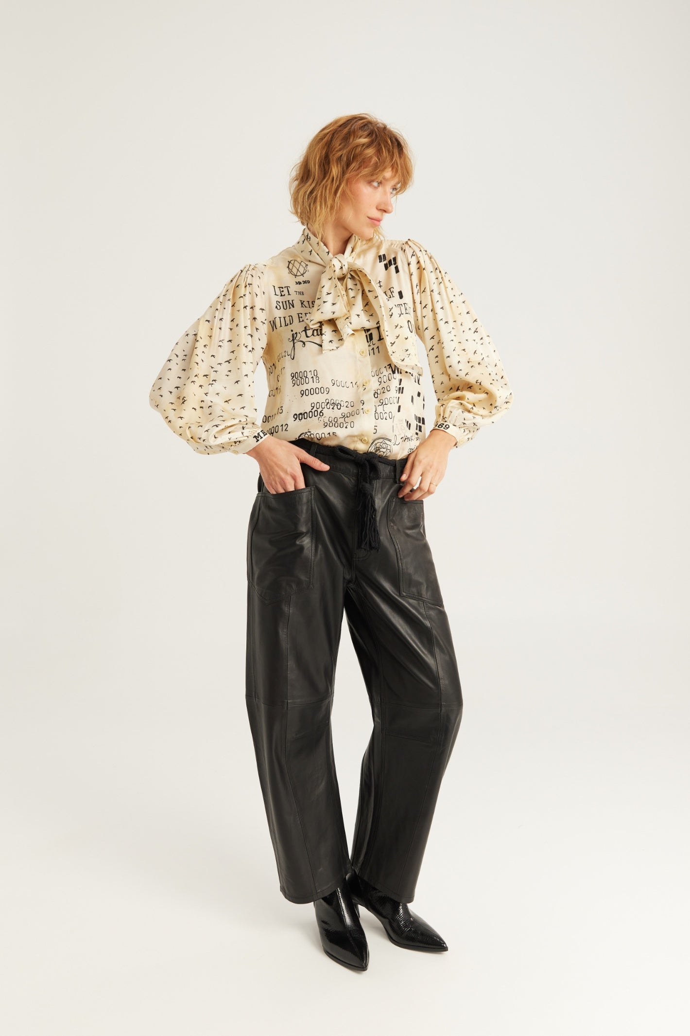Shop the ME369 Nola Printed Tie Shirt in Noir Muse at Dotique. A printed blouse with a statement tie neckline, voluminous sleeves and a soft viscose blend.