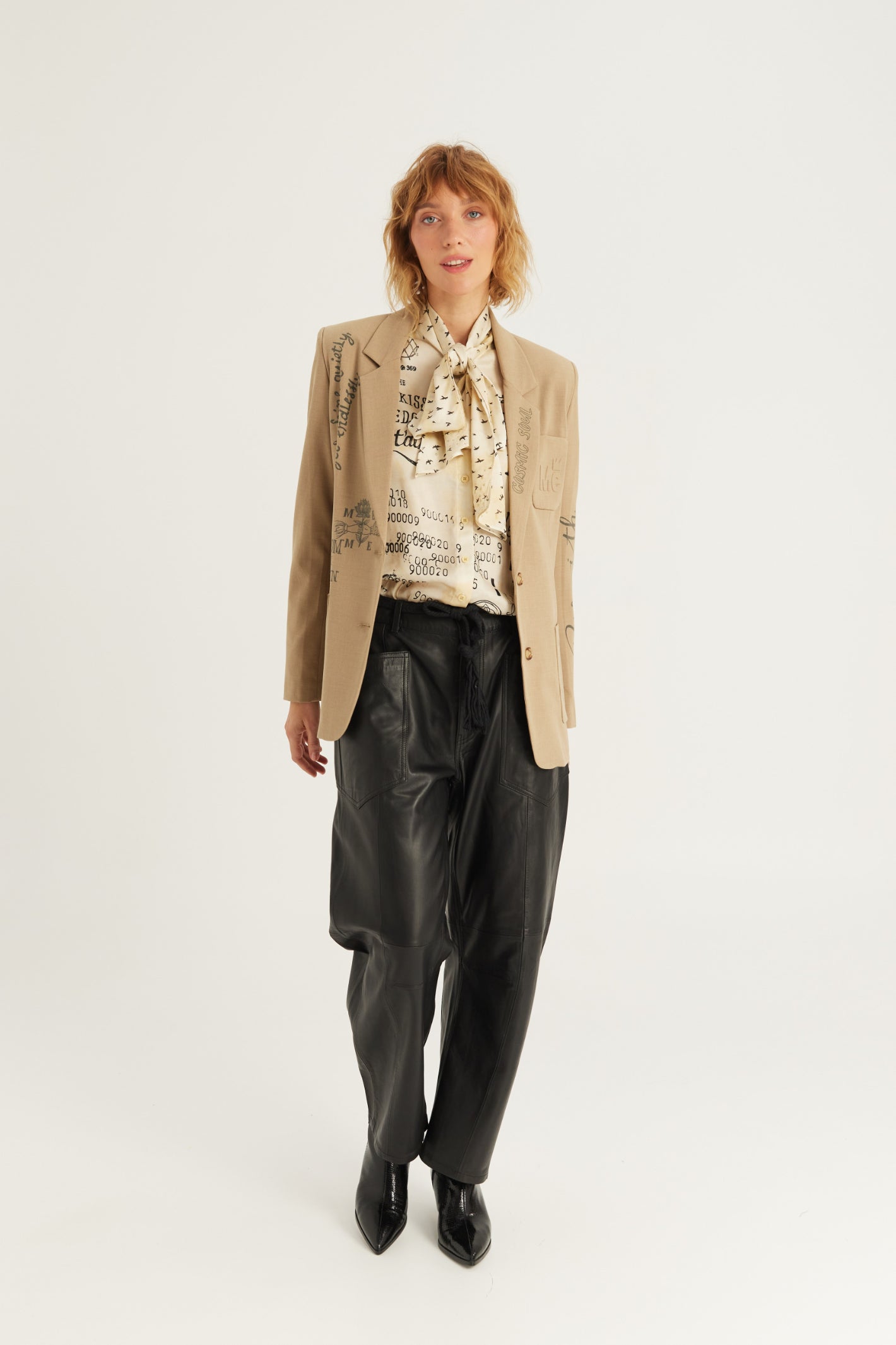Shop the ME369 Nola Printed Tie Shirt in Noir Muse at Dotique. A printed blouse with a statement tie neckline, voluminous sleeves and a soft viscose blend.