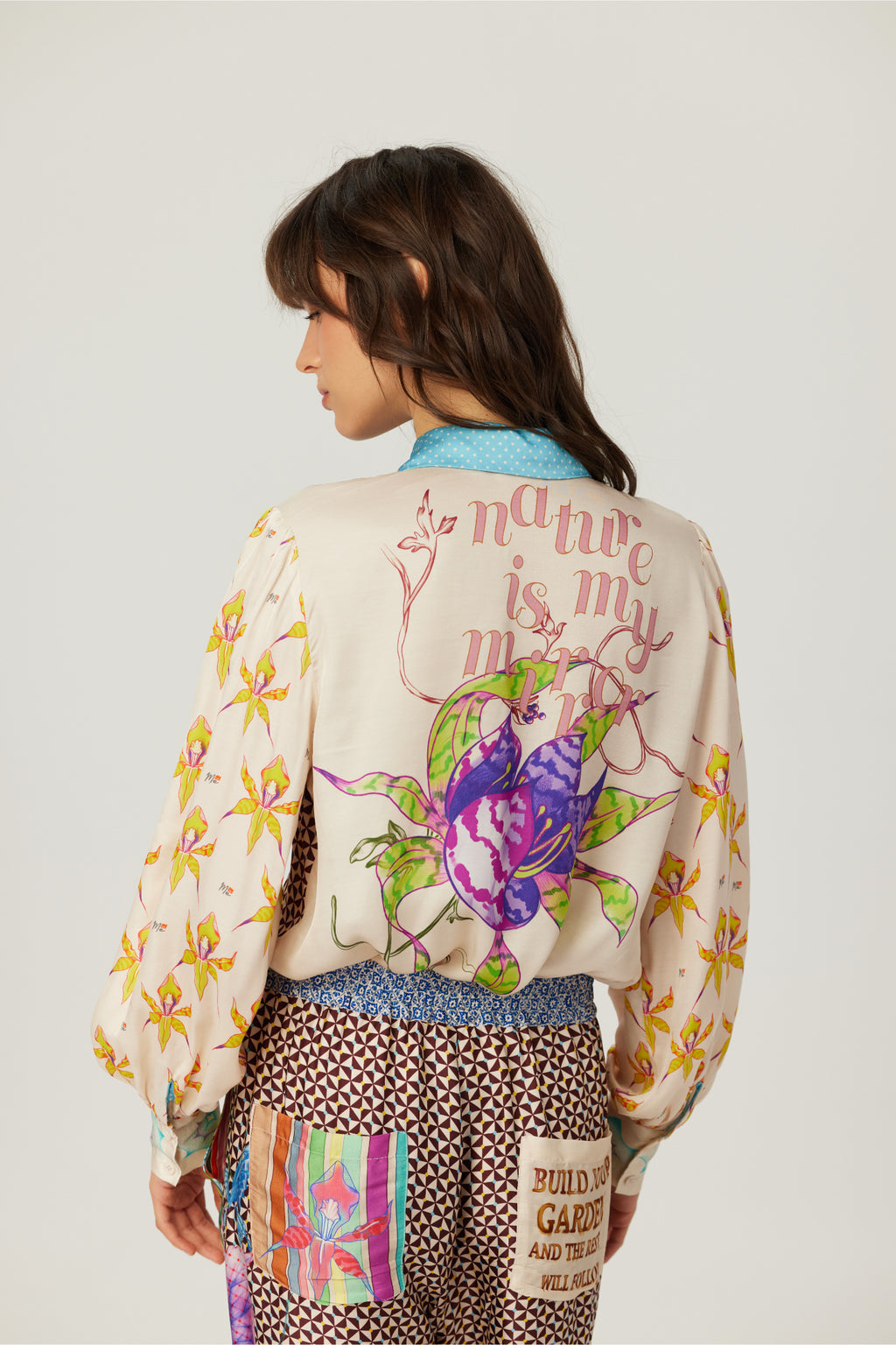 Shop the ME369 Sola Printed Puff Sleeve Blouse in Paradiso at Dotique. A soft printed blouse with puff sleeves, colourful artwork and signature ME369 styling.