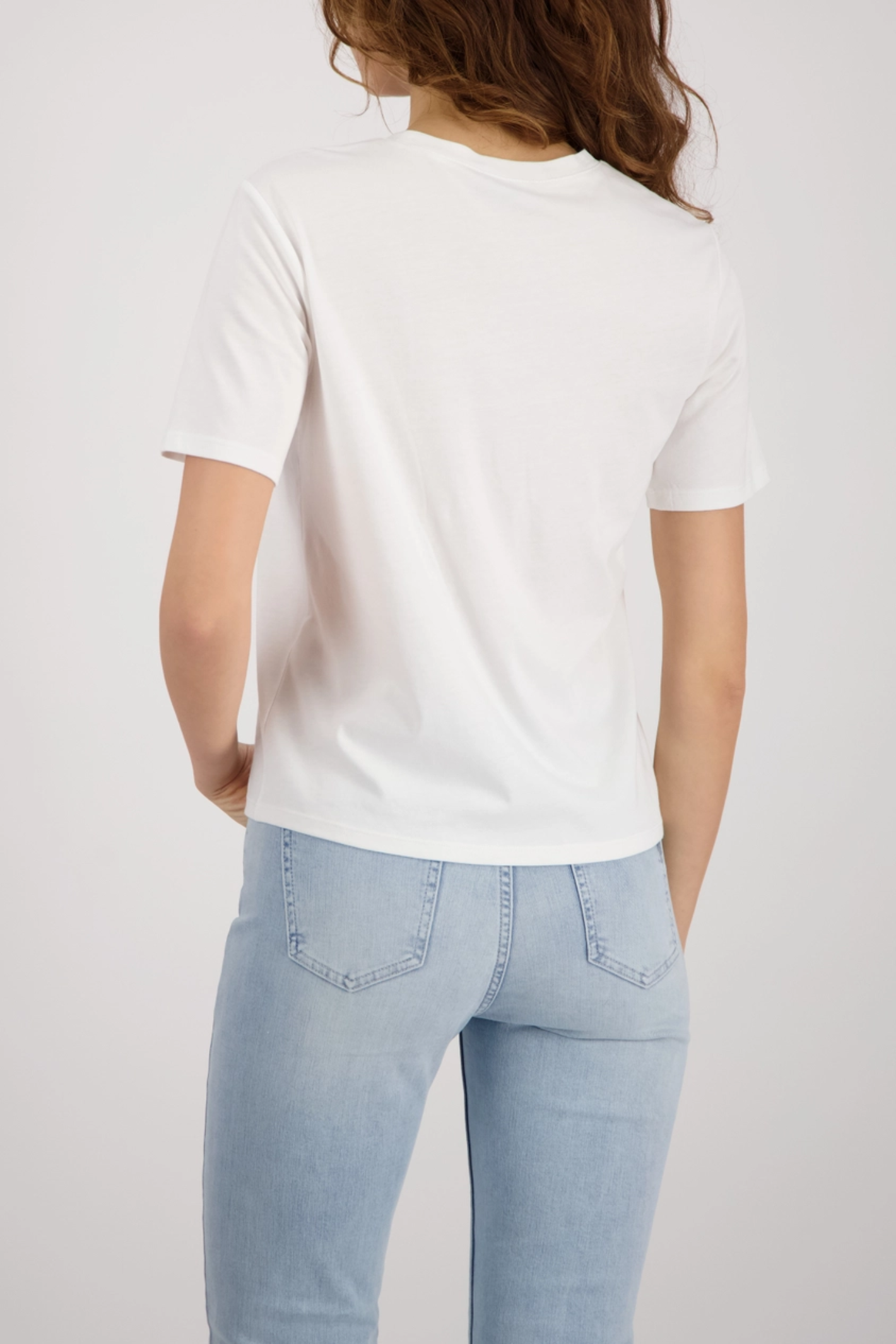 Back view of a woman wearing Monari 410132 Printed T-Shirt Off White Cotton Blend Short Sleeve Graphic Top by Monari, shop at Dotique.