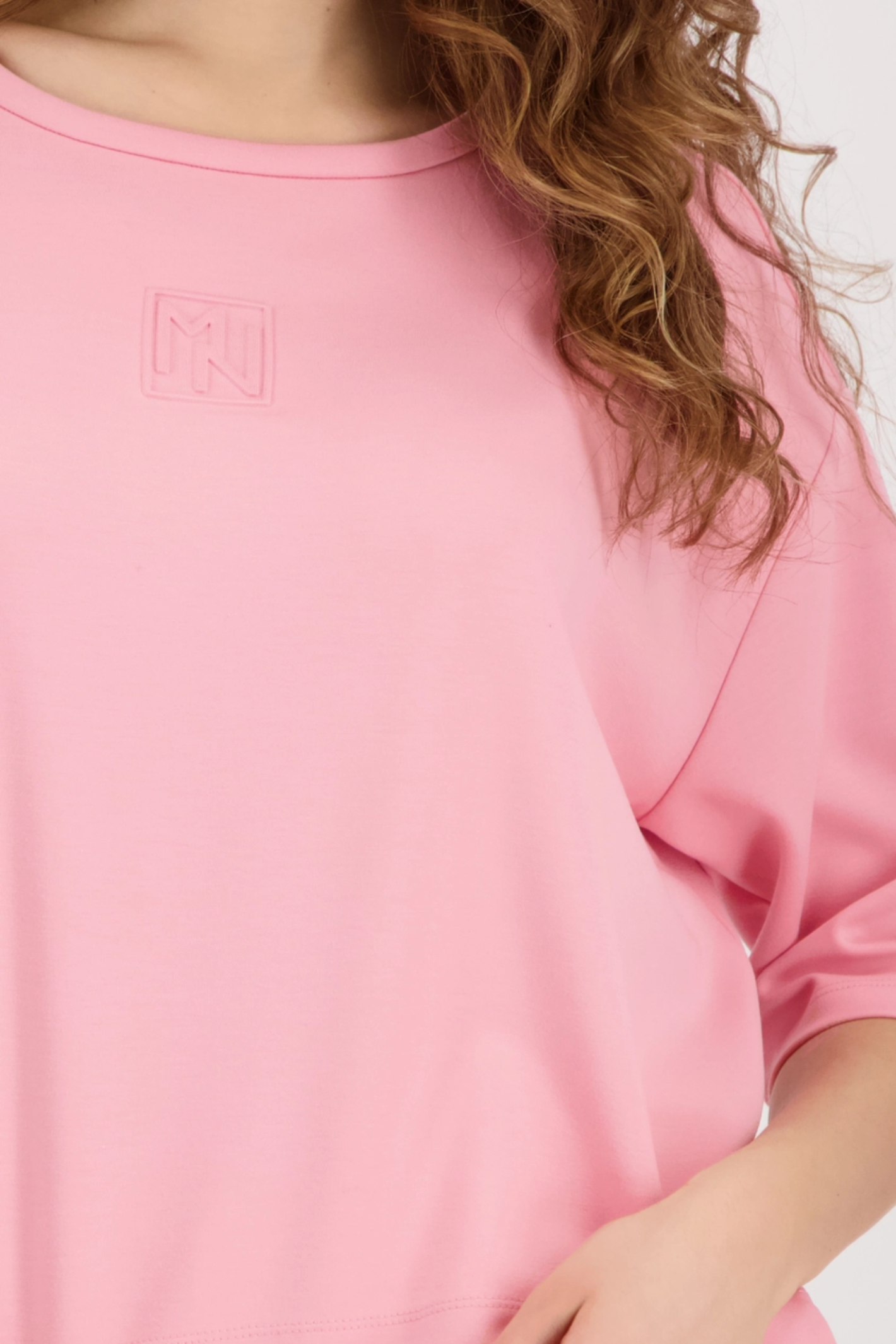 Close-up of pink Monari 410185 Embossed Emblem Sweatshirt Spring Flower with subtle emblem, shop Monari at Dotique.