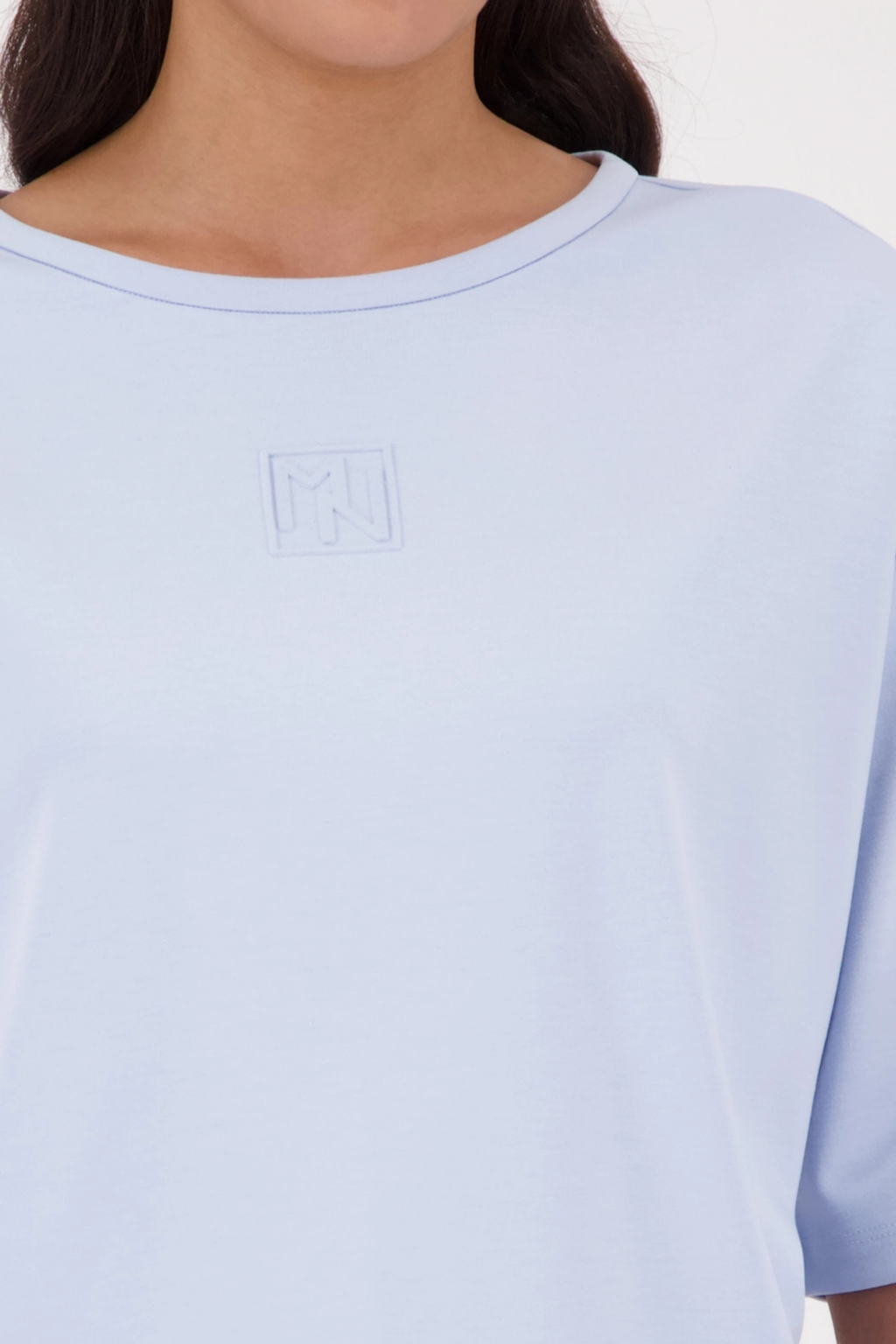Monari 410185 Pale Blue Embossed Emblem Sweatshirt close-up showing soft fabric detail, shop Monari at Dotique