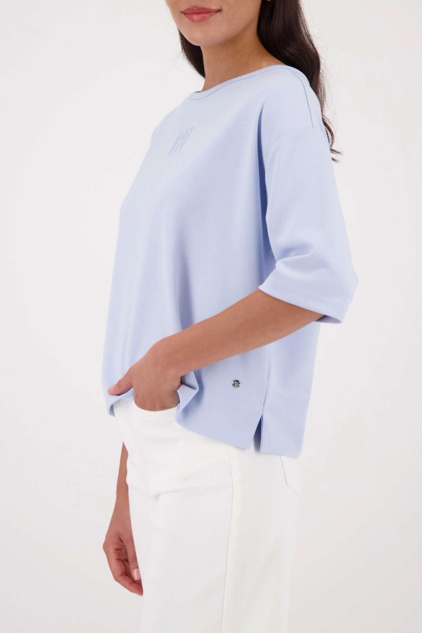 Monari 410185 Pale Blue Embossed Emblem Sweatshirt side view styled on model Shop Monari at Dotique for casual elegance