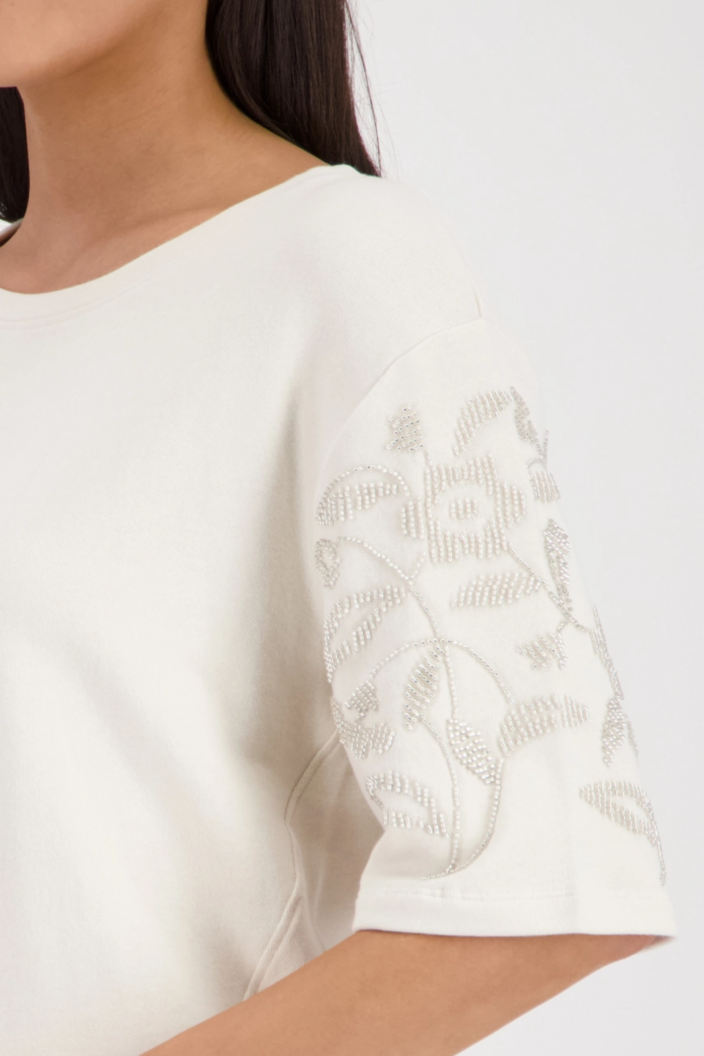 Monari 410257 Off-White Pearl Detail Cotton Sweatshirt sleeve close-up with floral pearl embellishment shop Monari at Dotique