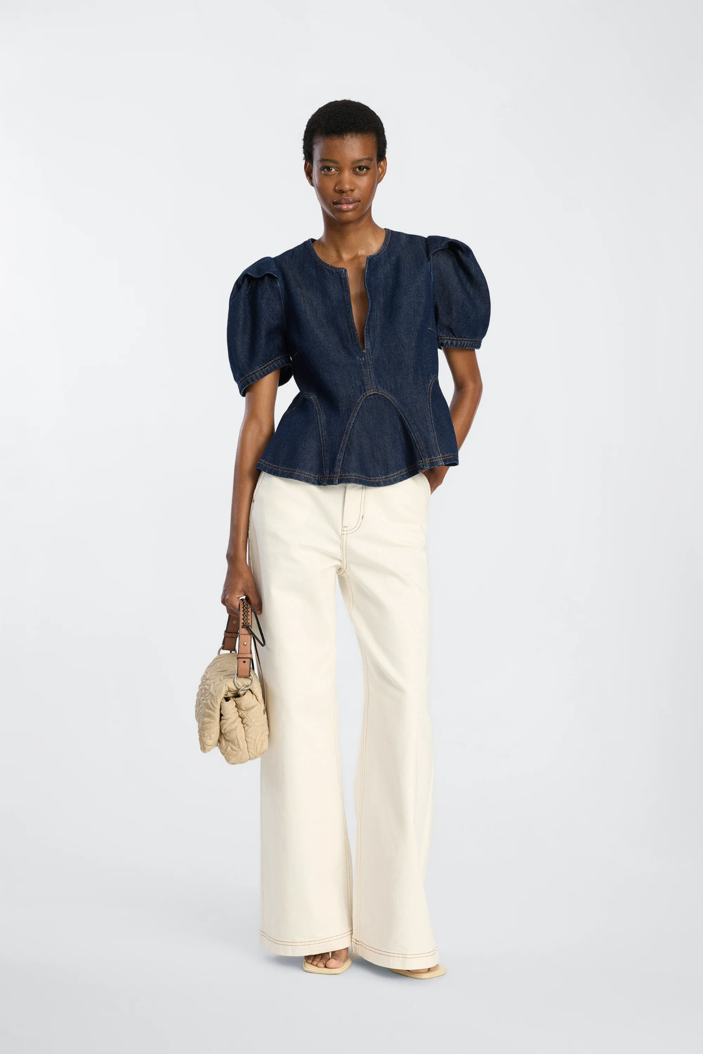 Shop the MUNTHE Baynor Top in Indigo at Dotique. Crafted from 100% TENCEL™ with contrast stitching, puff sleeves and a flattering A-line silhouette.