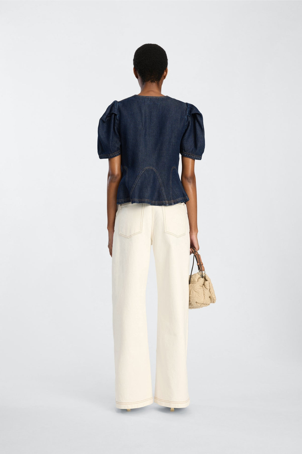 Shop the MUNTHE Baynor Top in Indigo at Dotique. Crafted from 100% TENCEL™ with contrast stitching, puff sleeves and a flattering A-line silhouette.