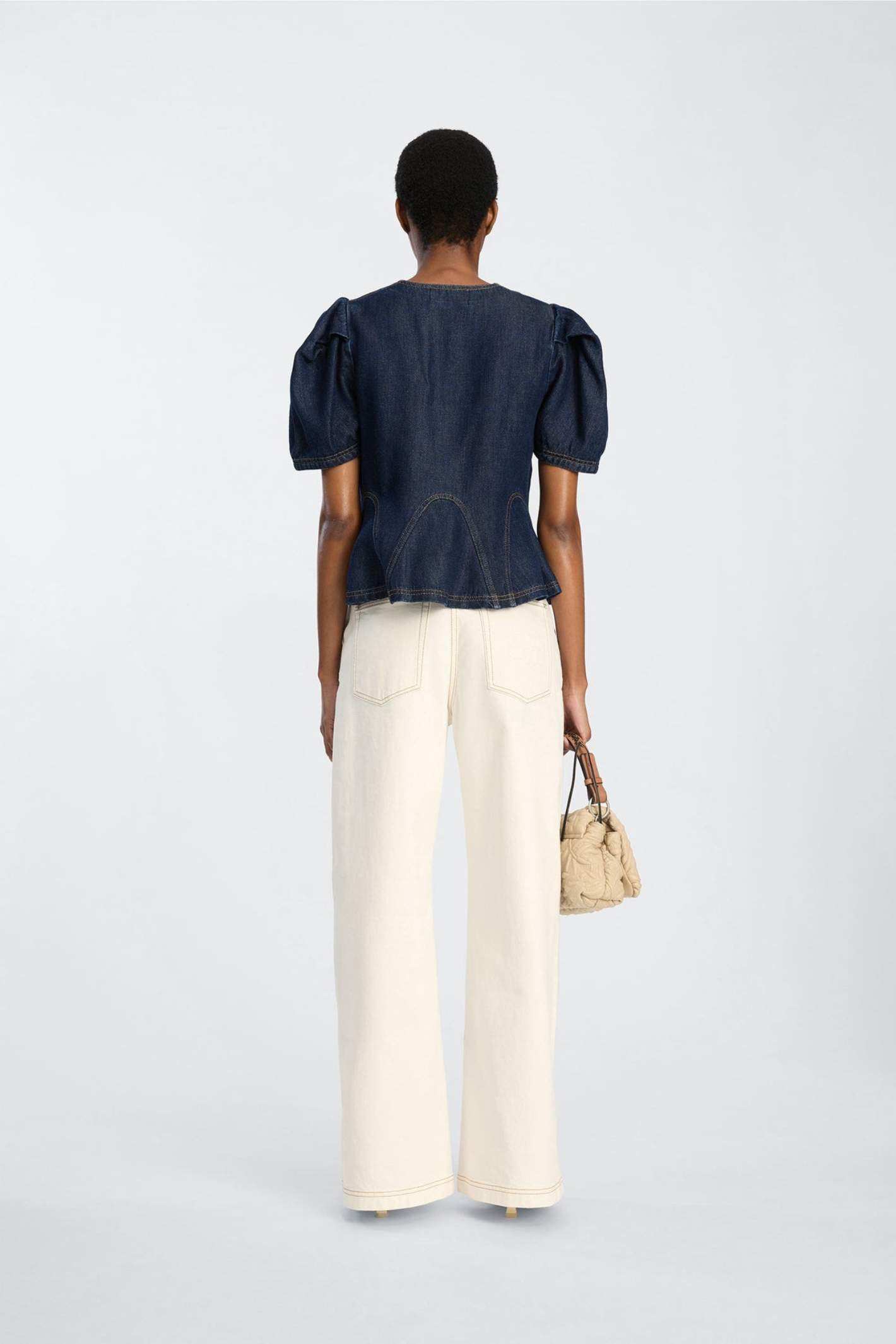 Shop the MUNTHE Baynor Top in Indigo at Dotique. Crafted from 100% TENCEL™ with contrast stitching, puff sleeves and a flattering A-line silhouette.