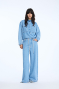 Shop the MUNTHE Obey Trousers in Light Blue at Dotique. Crafted from 100% TENCEL™ with a flattering wide-leg fit, tie waist and soft denim-look finish.