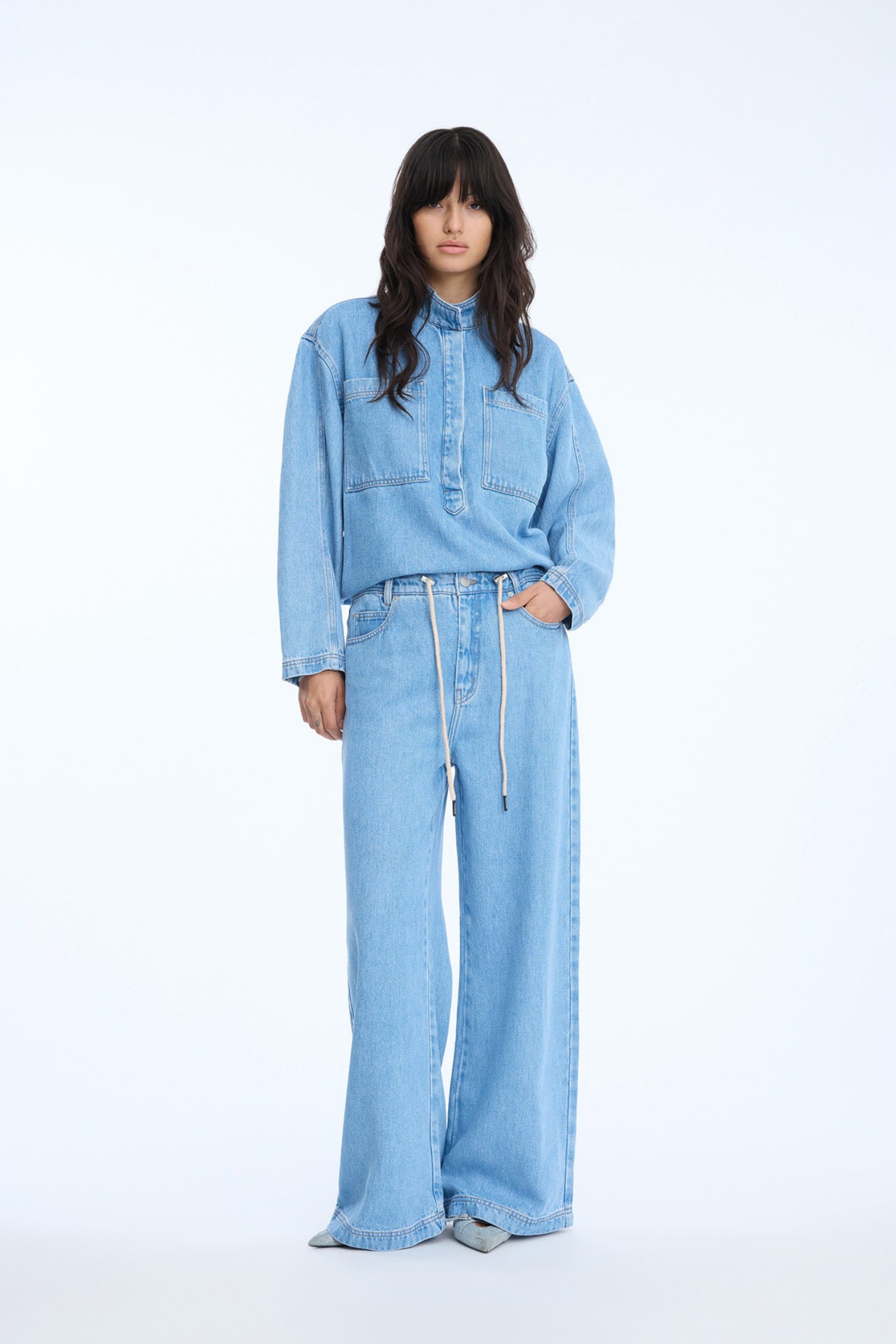 Shop the MUNTHE Obey Trousers in Light Blue at Dotique. Crafted from 100% TENCEL™ with a flattering wide-leg fit, tie waist and soft denim-look finish.